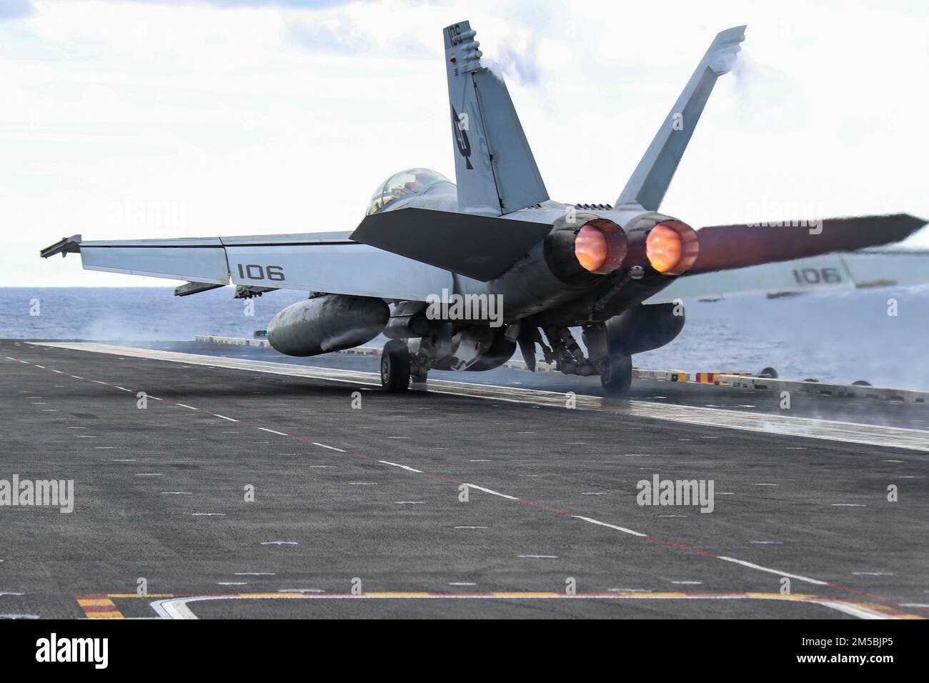PHILIPPINE SEA (Feb. 23, 2022) Capt. Michael Langbehn, commander, Carrier Air Wing (CVW) 9, and Capt. Brian A. Ribota, commodore, Destroyer Squadron 21, launch in an F/A-18F Super Hornet, assigned to the 'Black Aces' of Strike Fighter Squadron (VFA) 41, from the flight deck of the Nimitz-class aircraft carrier USS Abraham Lincoln (CVN 72). Abraham Lincoln Strike Group is on a scheduled deployment in the U.S. 7th Fleet area of operations to enhance interoperability through alliances and partnerships while serving as a ready-response force in support of a free and open Indo-Pacific region. Stock Photo