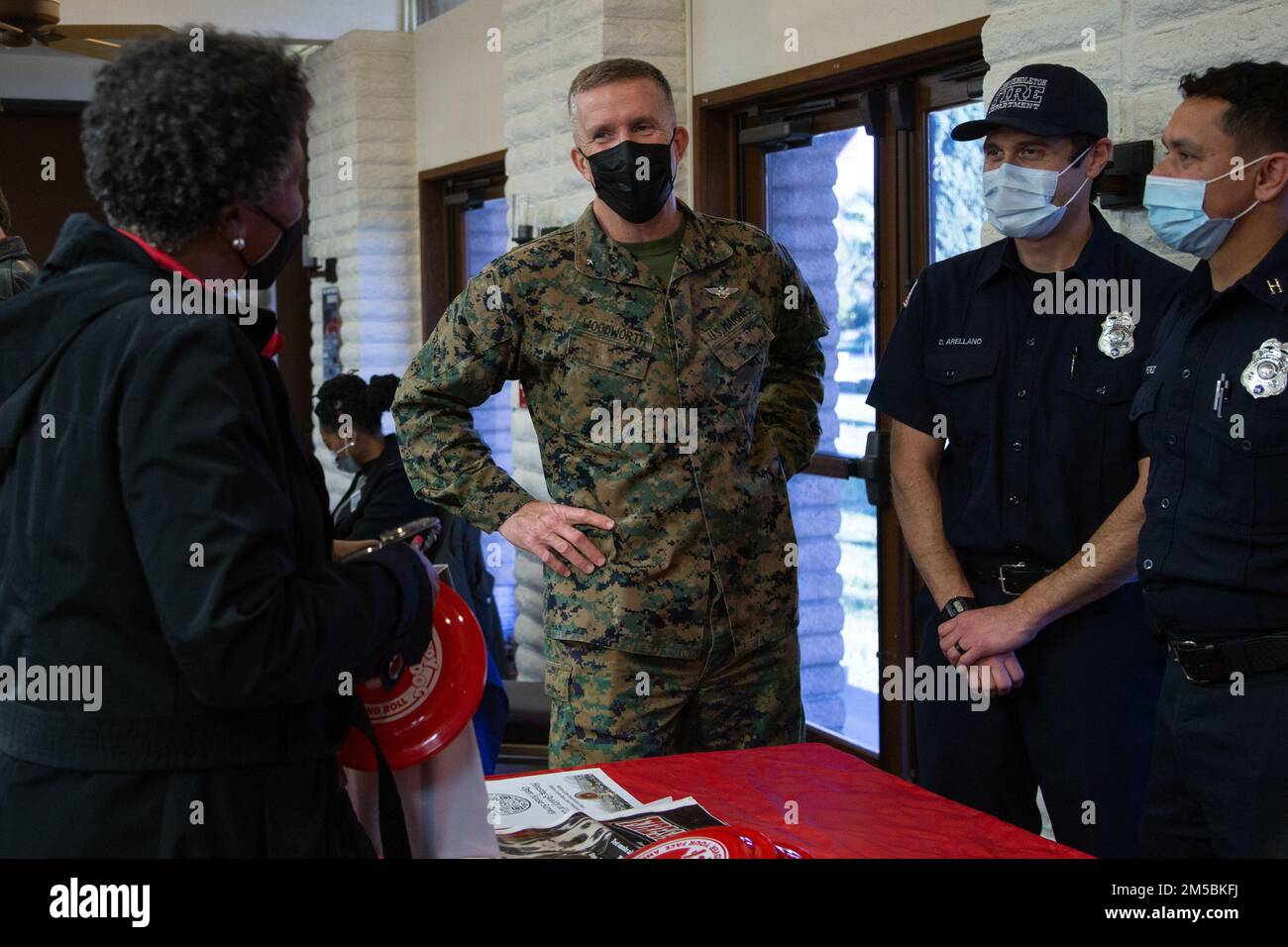 U.S. Marine Brig. Gen. Jason Woodworth, the commanding general of Marine Corps Installations West, Marine Corps Base Camp Pendleton, speaks with a Camp Pendleton resident at the Base Housing Quality of Life open house at Marine Corps Family Team Building Center on Marine Corps Base Camp Pendleton, California, Feb. 23, 2022. The open house was held to increase awareness of current procedures, services and various resources available to residents along with addressing housing related questions or concerns. Stock Photo