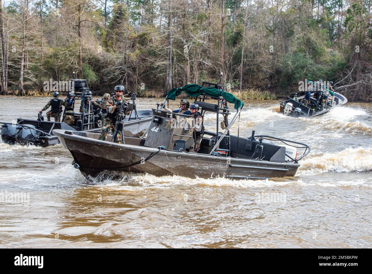 Naval Small Craft Instruction and Technical Training School (NAVSCIATTS) students from Estonia, Germany, Poland, and Romania participate in a Patrol Craft Officer Riverine (PCOR) training exercise on the Pearl River, near the John C. Stennis Space Center, Mississippi, February 22, 2022.    PCOR, is a seven-week course of instruction designed to provide international students with the knowledge and skills to operate a riverine patrol craft.    NAVSCIATTS is a Security Cooperation training command operating under U.S. Special Operations Command in support of Security Force Assistance and Geograp Stock Photo