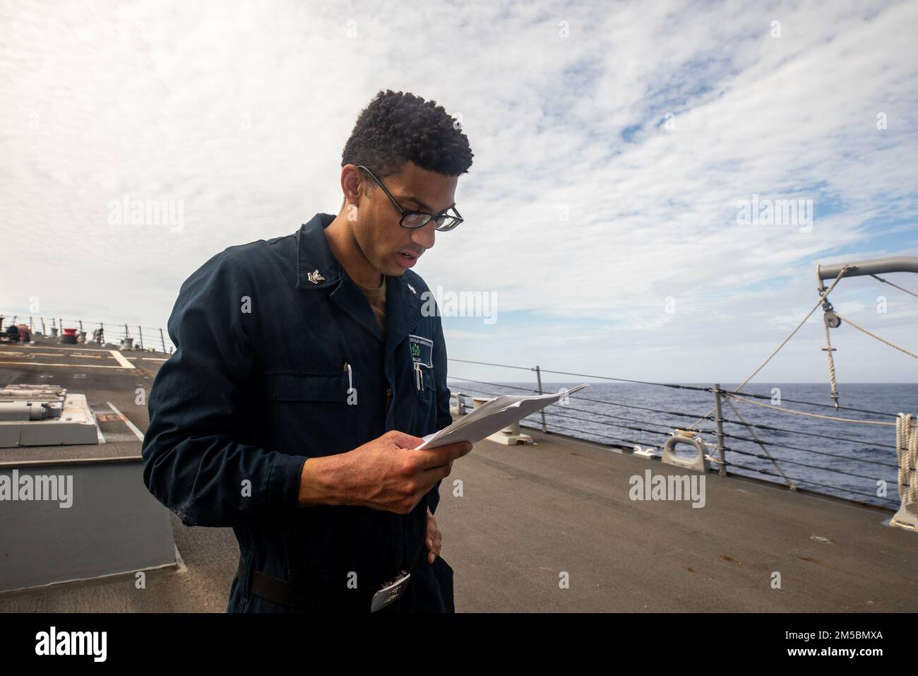 SOUTH CHINA SEA (Feb. 23, 2022) Culinary Specialist 2nd Class consults a checklist while conducting maintenance aboard Arleigh Burke-class guided-missile destroyer USS Ralph Johnson (DDG 114). Ralph Johnson is assigned to Task Force 71/Destroyer Squadron (DESRON) 15, the Navy’s largest forward-deployed DESRON and the U.S. 7th fleet’s principal surface force. Stock Photo