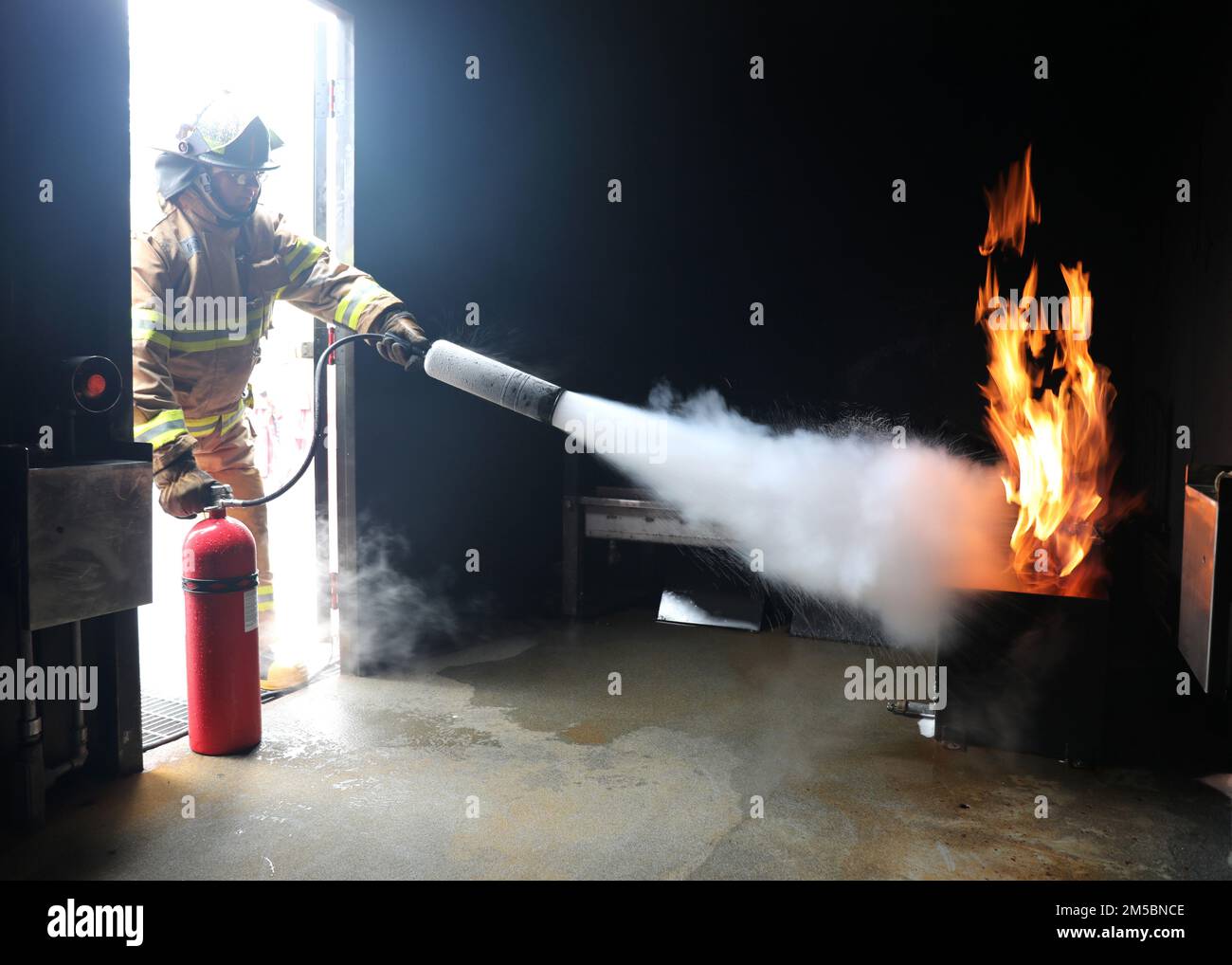 220223-N-OH262-0015--FORT EUSTIS, Va. (February 23, 2022)--A newly hired Civil Service Mariner (CIVMAR) uses a CO2 fire extinguisher to put out a simulated trash can fire at the Military Sealift Command Training Center East on Joint Base Langley-Fort Eustis, Virginia, Feb. 25. The training evolution was part of the MSC Basic Training Damage Control curriculum, which must be successfully completed prior to sailing in MSC's fleet of ships. Stock Photo