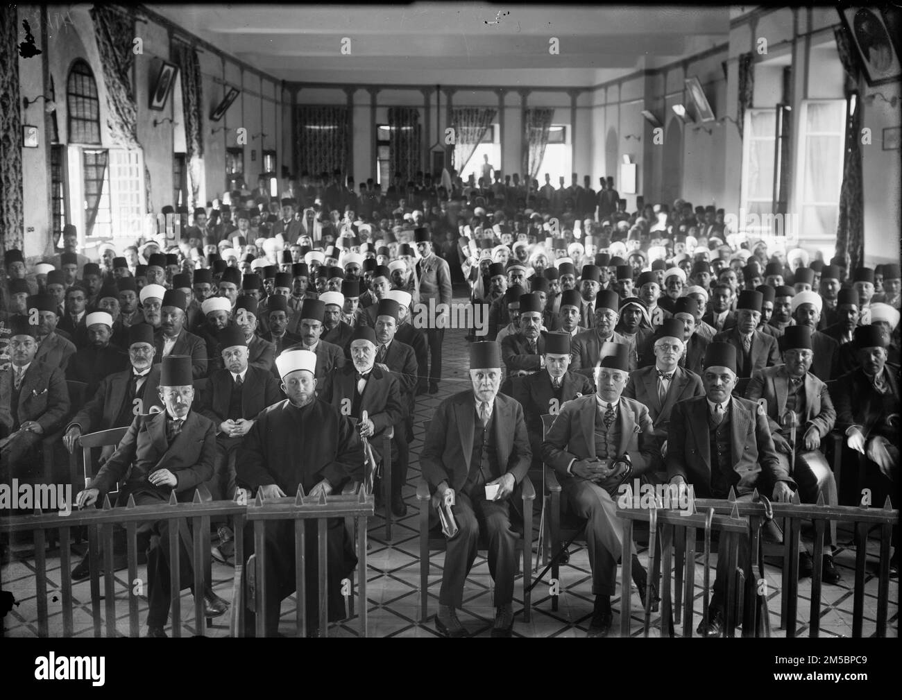 An Arab 'protest gathering' in session during the British Mandate in Palestine, in the Rawdat el Maaref hall, 1929. From left to right : unknown – Amin al-Husayni – Musa al-Husayni – Raghib al-Nashashibi – unknown Stock Photo