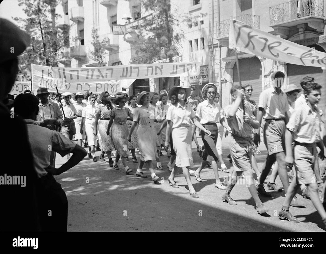 Jewish protest demonstrations against Palestine White Paper, May 18, 1939. Zionist young men & girls parading on King George Avenue in Jerusalem, Following the London Conference (1939) the British Government published a White Paper which proposed a limit to Jewish immigration from Europe, restrictions on Jewish land purchases, and a program for creating an independent state to replace the Mandate within ten years. Stock Photo