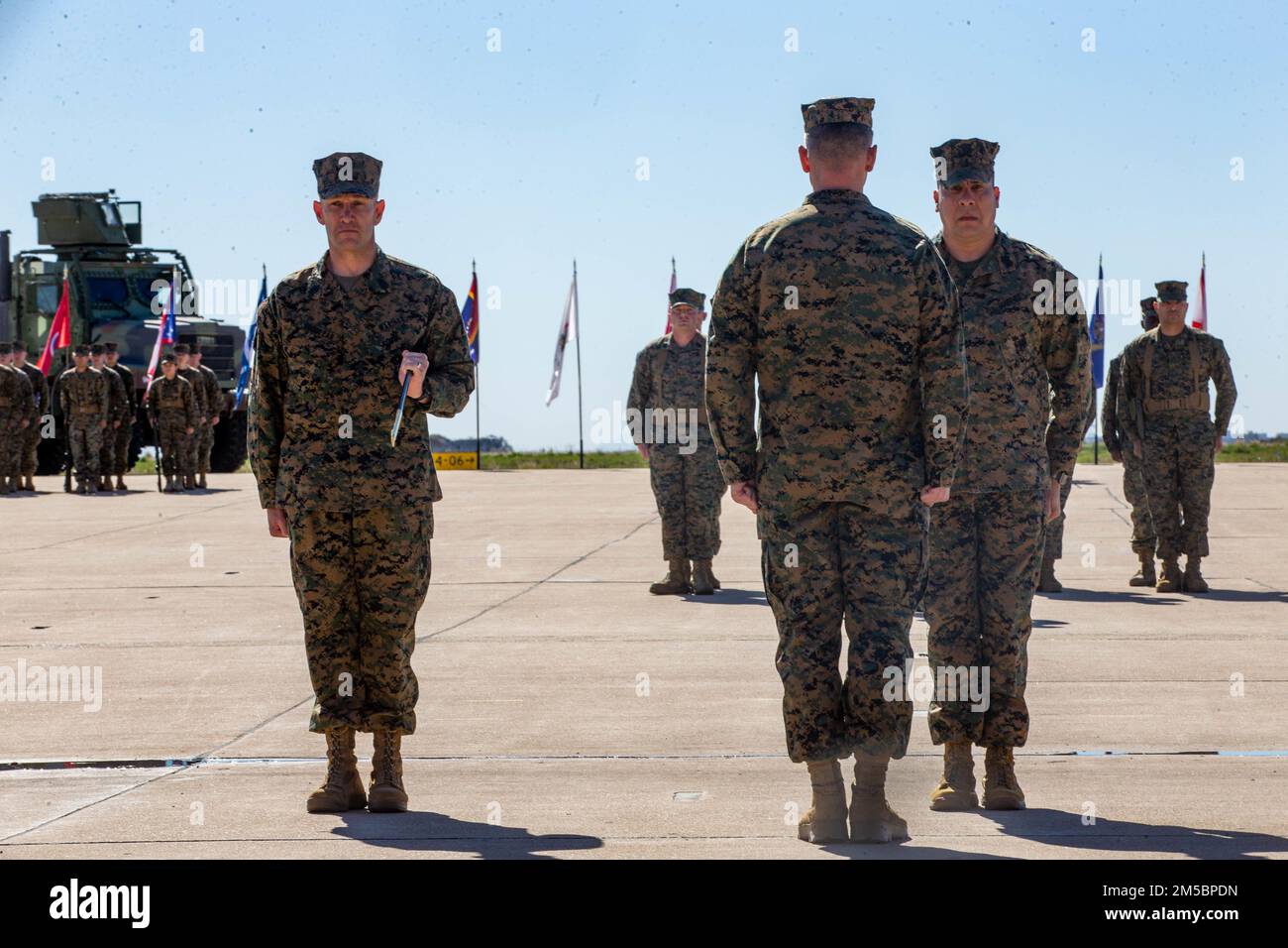 U.S. Marine Corps Col. Jeremy S. Winters, center, commanding officer of Marine Air Control Group (MACG) 38, 3rd Marine Aircraft Wing, Sgt. Maj. Allen B. Goodyear, left, outgoing sergeant major of MACG-38, and Sgt. Maj. Gerardo C. Ybarra, right, incoming sergeant major of MACG-38, prepare to exchange the noncommissioned officer sword during a relief and appointment ceremony on Marine Corps Air Station Miramar, California, Feb 24, 2022. A relief and appointment ceremony is a time-honored tradition, which formally signifies the transfer of responsibility and entails the total accountability and a Stock Photo