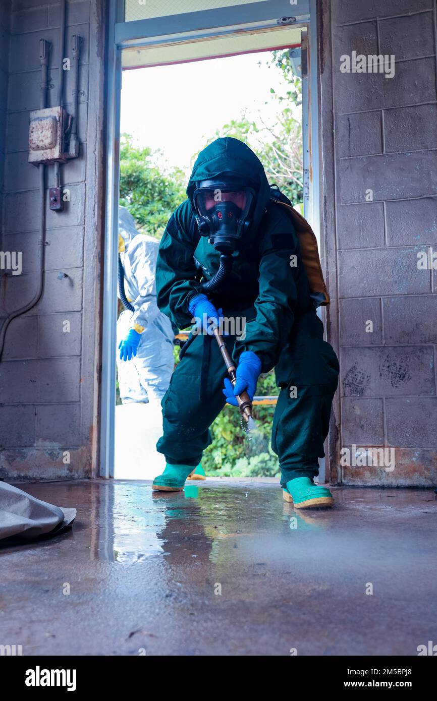 A U.S. Marine with Marine Wing Headquarter Squadron (MWHS-1) decontaminates the floor at Marine Corps Air Station Futenma, Okinawa, Japan, Feb. 24, 2022. Chemical, Biological, Radiological, and Nuclear Defense (CBRN) is responsible for conducting training and reconnaissance, chemical detection identification, biological agent collection and sampling, decontamination of personnel, equipment, and casualties and individual protective measures in first aid for unit personnel. Stock Photo