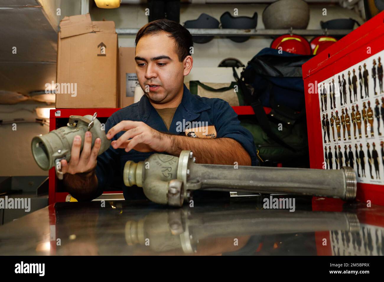 PHILIPPINE SEA (Feb. 24, 2022) Damage Controlman Fireman John Mancia, from Dallas, takes inventory of dewatering equipment in a repair locker aboard the Nimitz-class aircraft carrier USS Abraham Lincoln (CVN 72). Abraham Lincoln Strike Group is on a scheduled deployment in the U.S. 7th Fleet area of operations to enhance interoperability through alliances and partnerships while serving as a ready-response force in support of a free and open Indo-Pacific region. Stock Photo