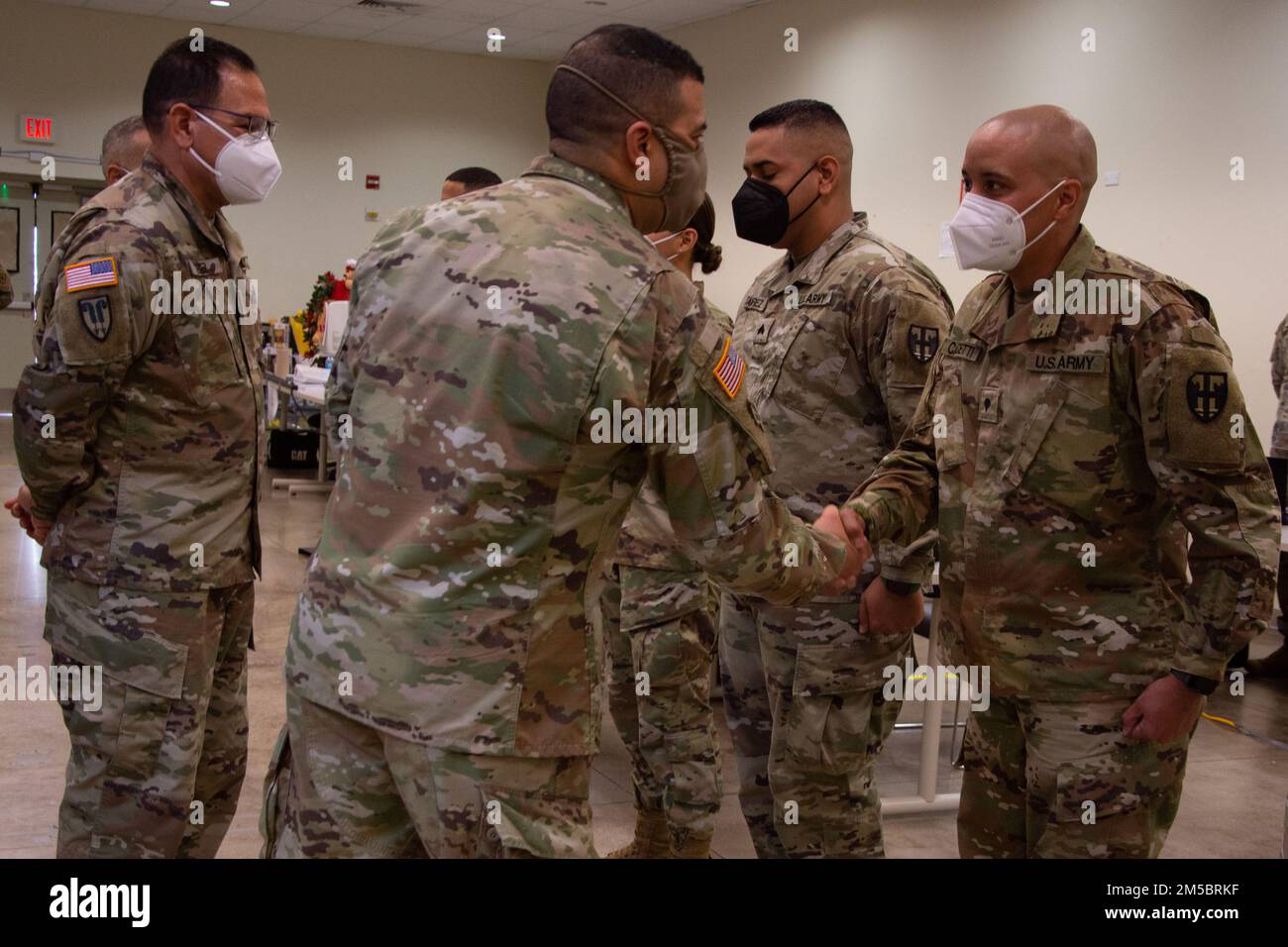 Maj. Gen. John C. Andonie, deputy director of the Army National Guard, greets Spc. Danny Capacetti, after giving him a coin of excellence for standing out in his tasks at Fort Buchanan, Puerto Rico, Feb. 24, 2022. Spc. Capacetti managed to integrate and reflect his leadership by taking the time to teach, mentor, and help others with a positive and motivational attitude that encompasses the whole workspace. Stock Photo