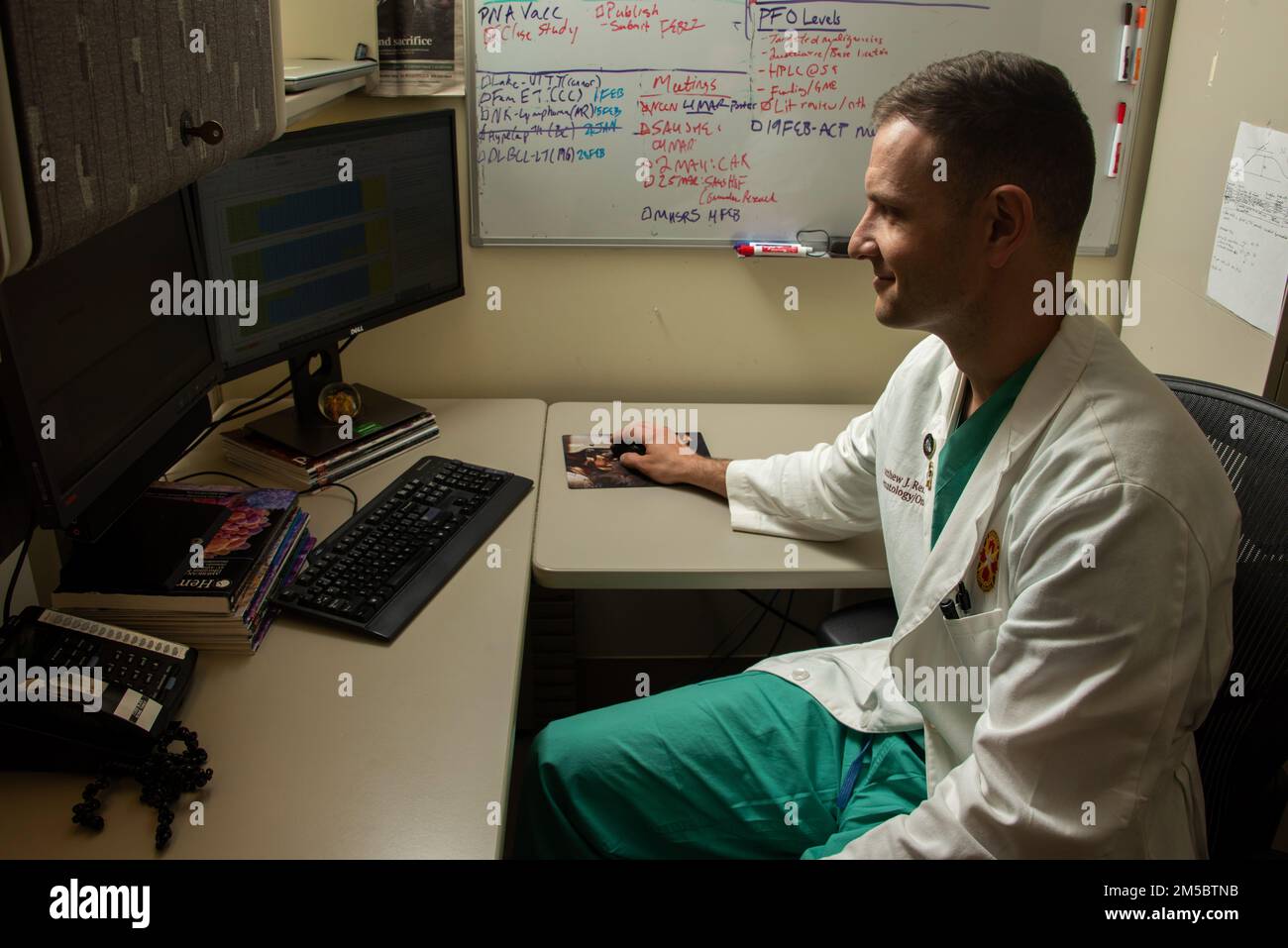 Air Force Capt. (Dr.) Matthew Rendo, Chief Hematology and Oncology Fellow, interprets data on how chemotherapy impacts COVID-19 vaccine response at Brooke Army Medical Center, Fort Sam Houston, Texas, Feb. 24, 2022. Rendo is spearheading the largest DOD study assessing the impact of chemotherapy and immunotherapies on the efficacy of COVID-19 vaccination in patients with cancer. Stock Photo