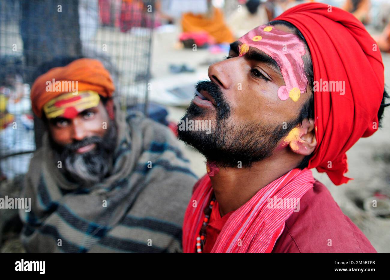 A Shaivite sadhu smoking chillum on the Mallick Ghat by the Hooghly river in Kolkata, India. Stock Photo