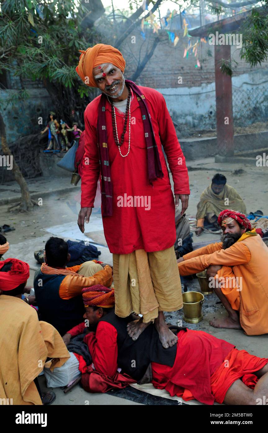 A Sadhu treating his fellow sadhu friend with Ashiatsu walking on the