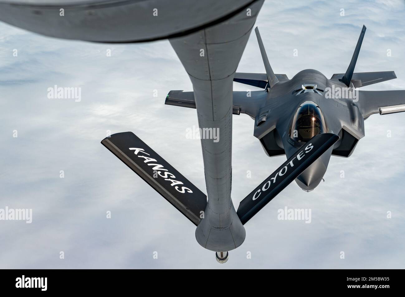 An F-35A Lightning II from the 354th Fighter Wing, Eielson Air Force Base, Alaska, approaches a KC-135 Stratotanker assigned to the 117th Air Refueling Squadron, Forbes Field Air National Guard Base, Topeka, Kansas, over the Indo-Pacific theater, Feb. 24, 2022. The F-35As are currently deployed to Kadena Air Base, Japan, conducting integrated operations with joint partners and allies to ensure a free and open Indo-Pacific region. Stock Photo
