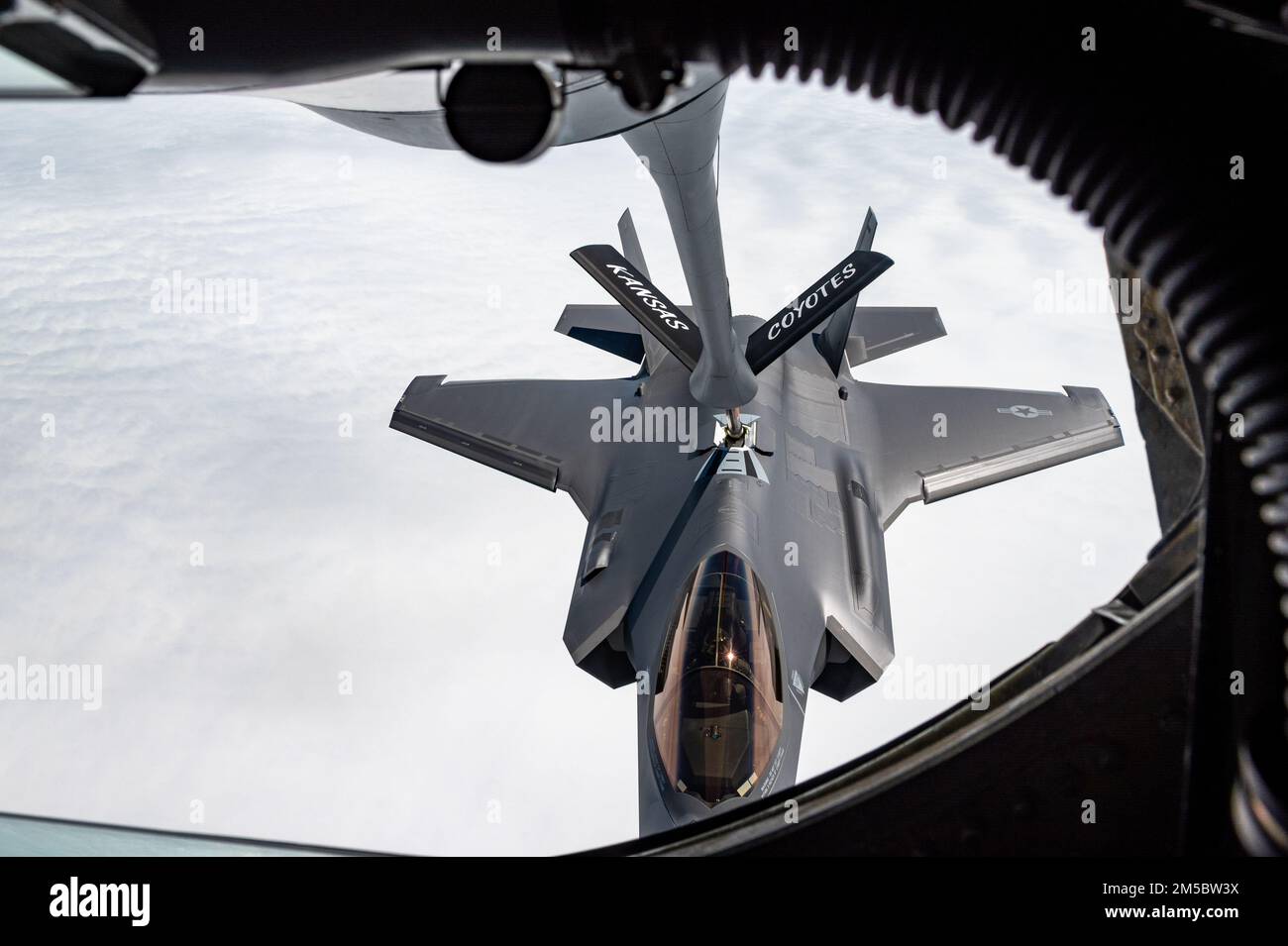 An F-35A Lightning II from the 354th Fighter Wing, Eielson Air Force Base, Alaska, receives fuel from a KC-135 Stratotanker assigned to the 117th Air Refueling Squadron, Forbes Field Air National Guard Base, Topeka, Kansas, over the Indo-Pacific theater, Feb. 24, 2022.  The F-35As are currently deployed to Kadena Air Base, Japan, conducting integrated operations with joint partners and allies to maintain a free and open Indo-Pacific region. Stock Photo