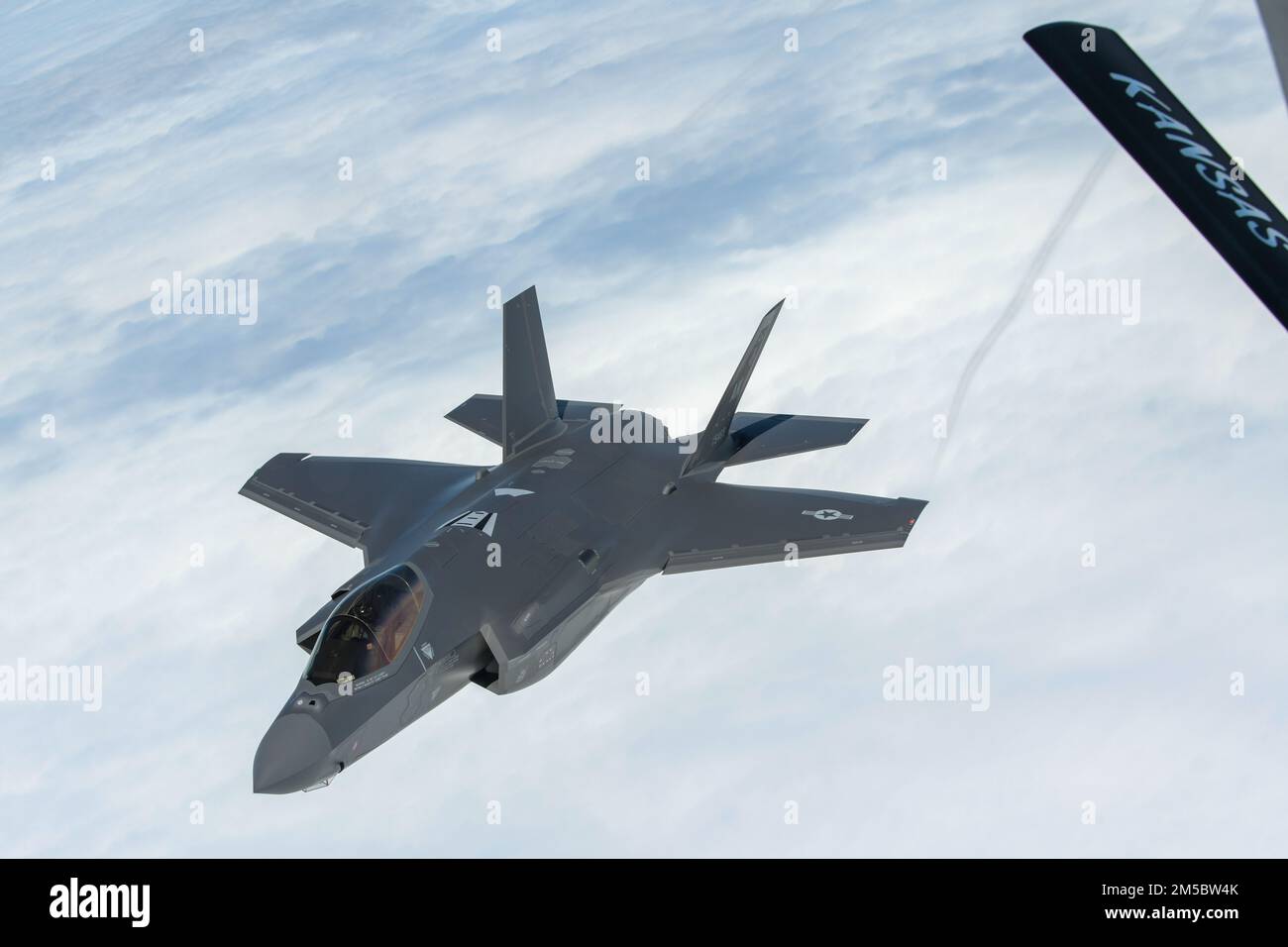 An F-35A Lightning II from the 354th Fighter Wing, Eielson Air Force Base, Alaska, departs from a KC-135 Stratotanker assigned to the 117th Air Refueling Squadron, Forbes Field Air National Guard Base, Topeka, Kansas, after receiving fuel over the Indo-Pacific theater, Feb. 24, 2022.  The F-35As are currently deployed to Kadena Air Base, Japan, conducting integrated operations with joint partners and allies to maintain a free and open Indo-Pacific region. Stock Photo