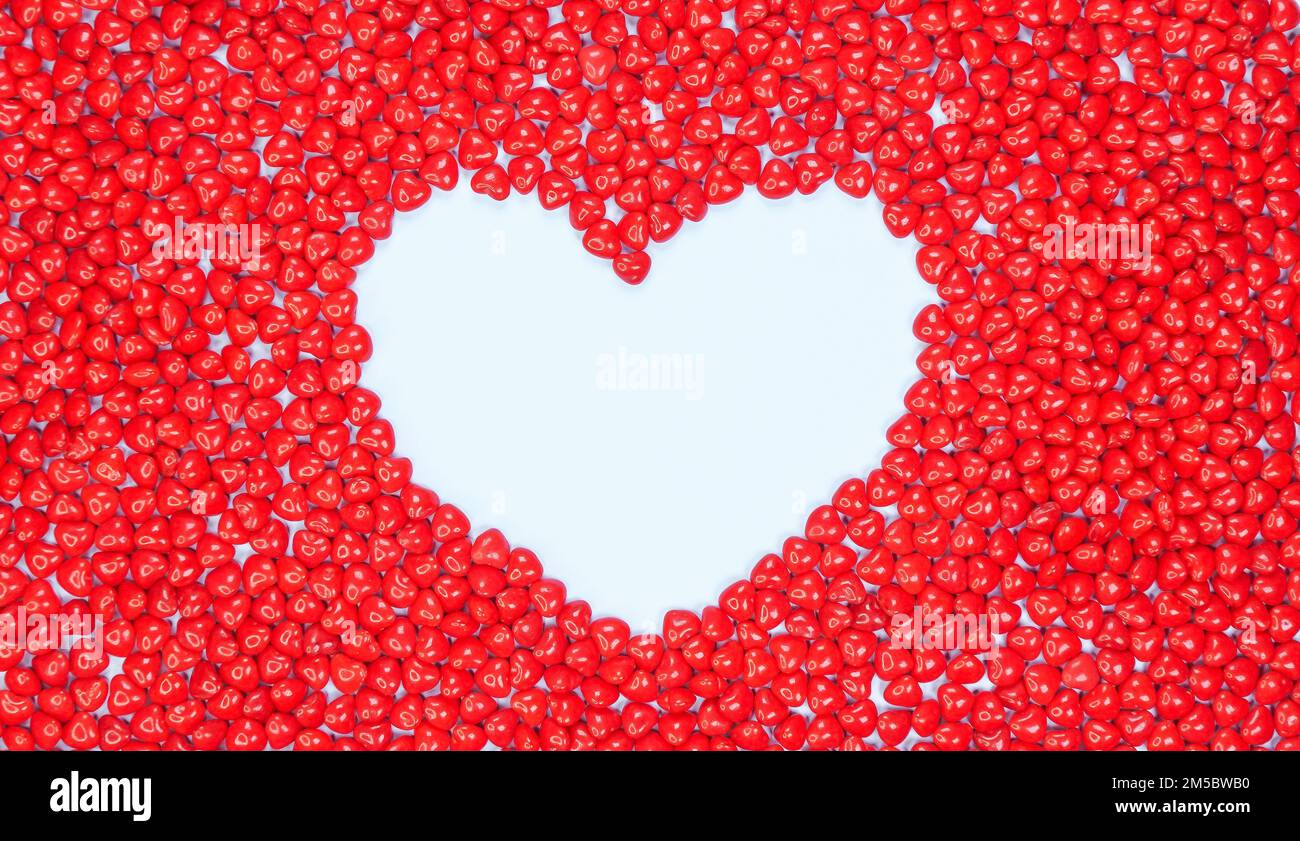 Big heart lined with candy hearts on light blue background. Pink, white, red hearts. Peppermint candy love. Valentine Day. Lots of little hearts. Copy Stock Photo