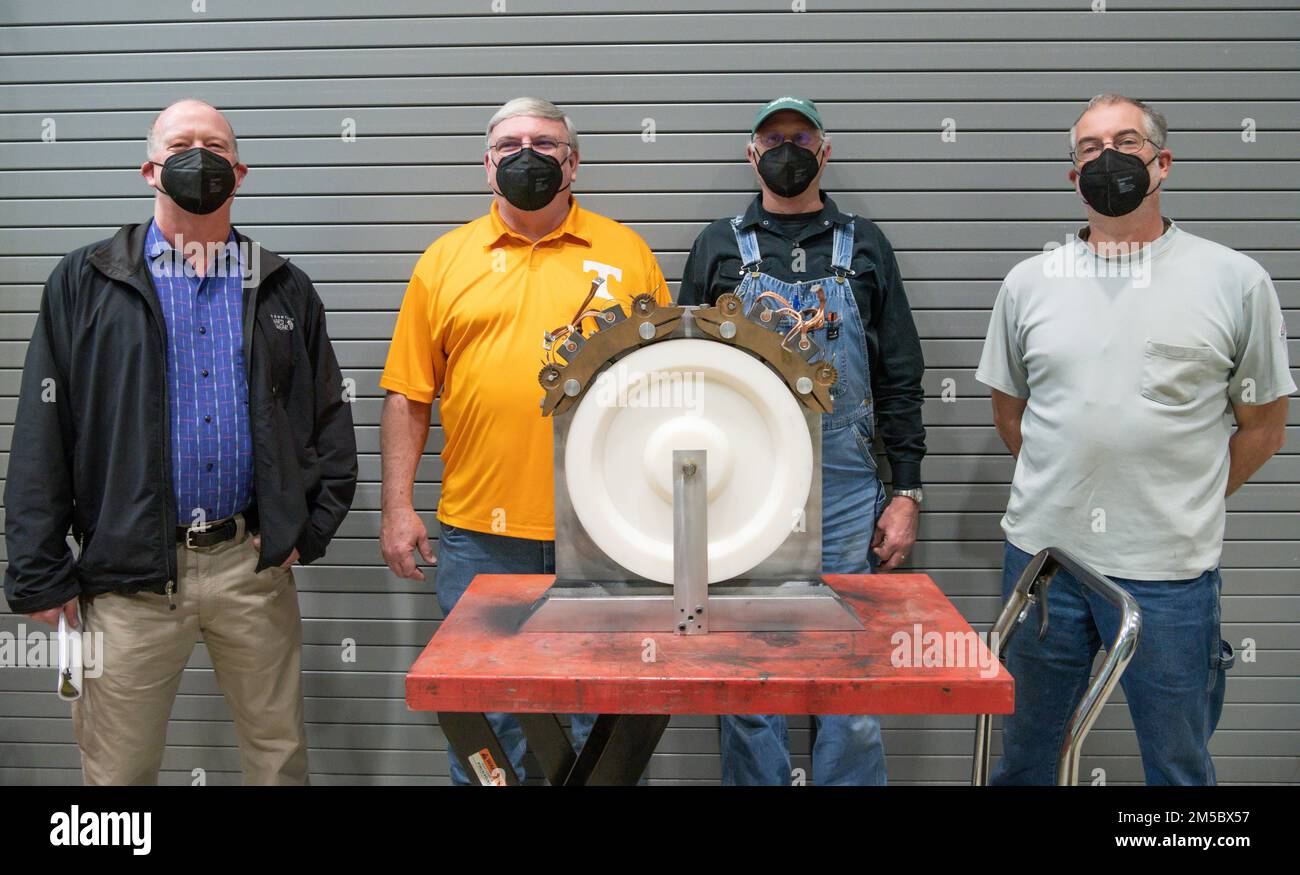 From left, Gary Jarrell, an operations engineer; Bruce Jones, an engineer tech specialist; Joel Sizemore, an aerospace machinist; and Carlos Bussche, an electrician, stand behind the device they designed and built to surface motor brushes prior to installing them at Arnold Air Force Base, Tenn., Feb. 24, 2022. Not pictured is Eddie Lee. Stock Photo