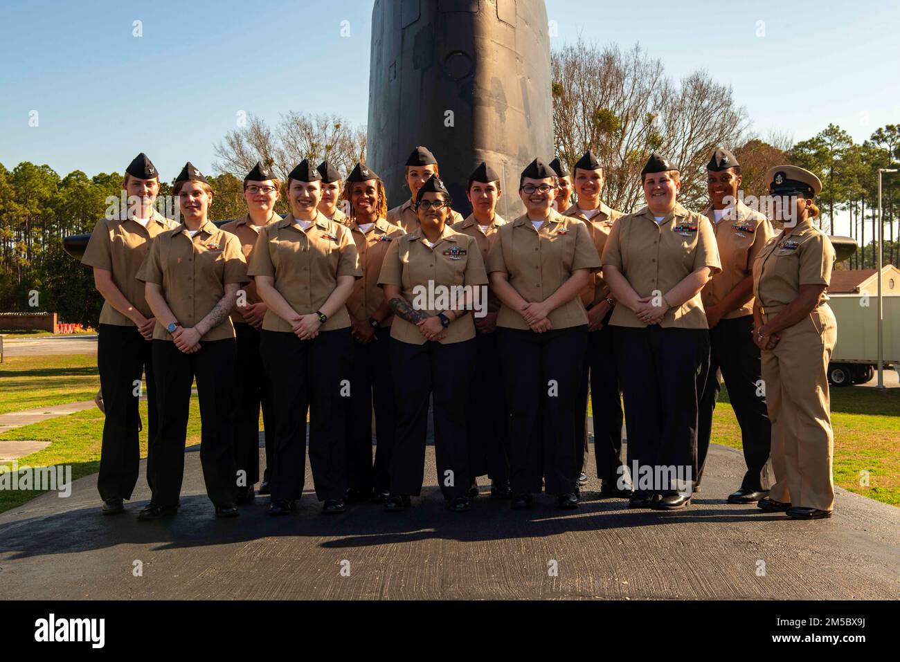 KINGS BAY, Ga. (Feb. 24, 2022) The enlisted women assigned to the Blue Crew of the Ohio-class ballistic-missile submarine USS Wyoming (SSBN 742) stand in formation at the USS Bancroft static display outside the gate at Naval Submarine Base Kings Bay, Georgia. The 15 submariners recently made history when they became the first enlisted female crew to complete a ballistic-missile submarine deterrent patrol. Wyoming is homeported at the base which is home to all East Coast Ohio-class submarines. Stock Photo