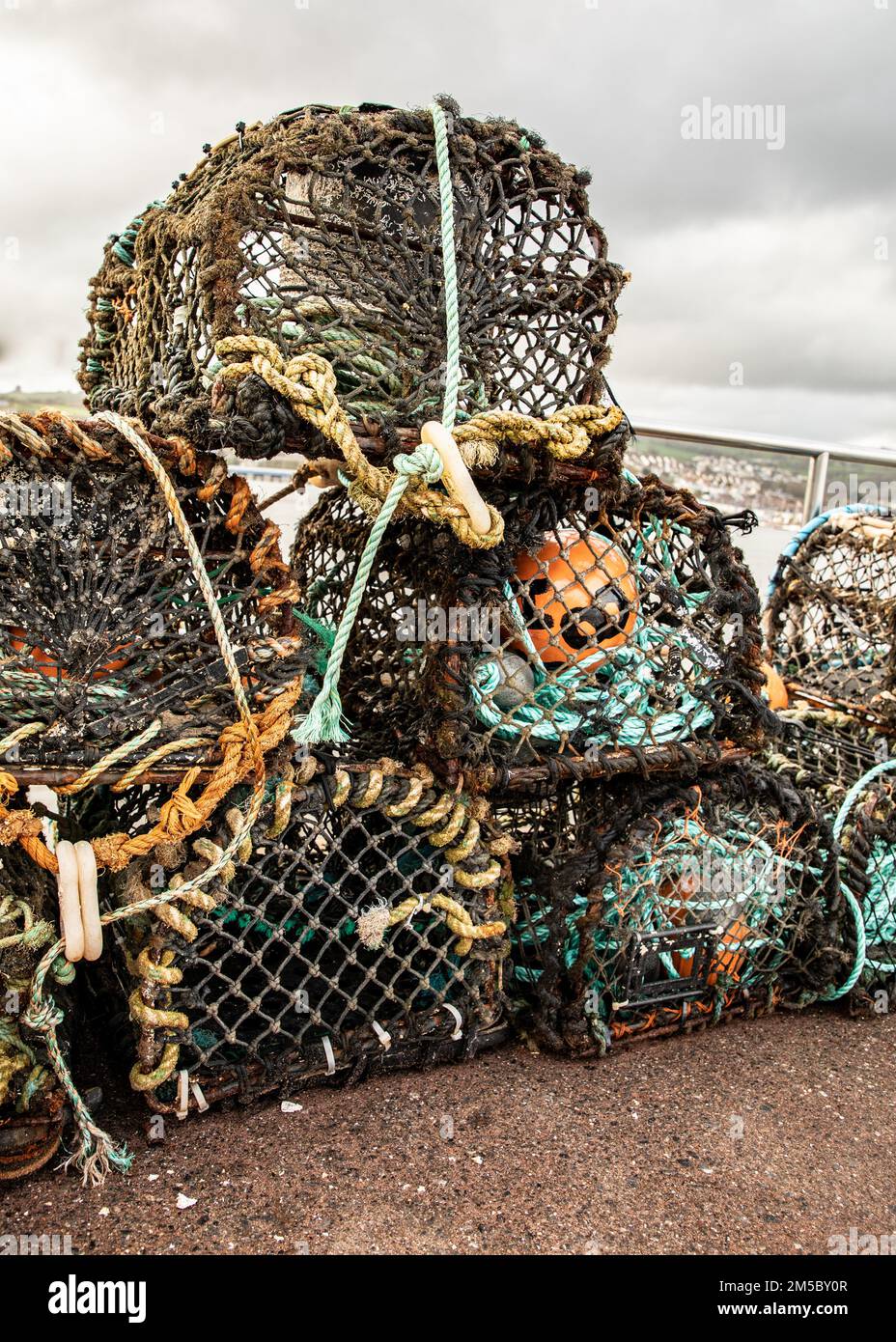 A vertical shot of fishermen's lobster pots on a pile drying on a