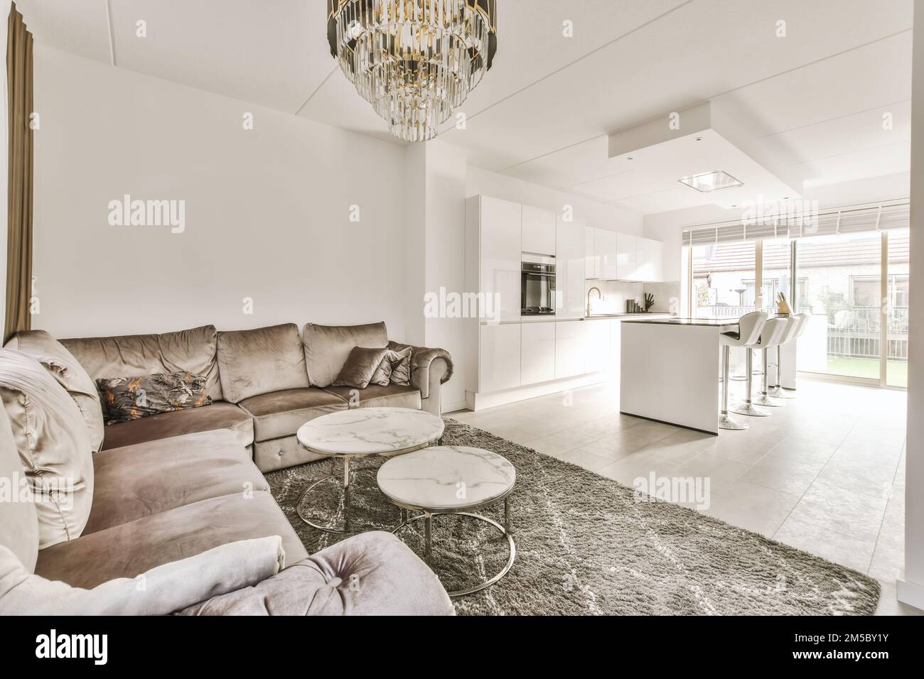 a living room with couches, coffee table, and chandels on the wall in