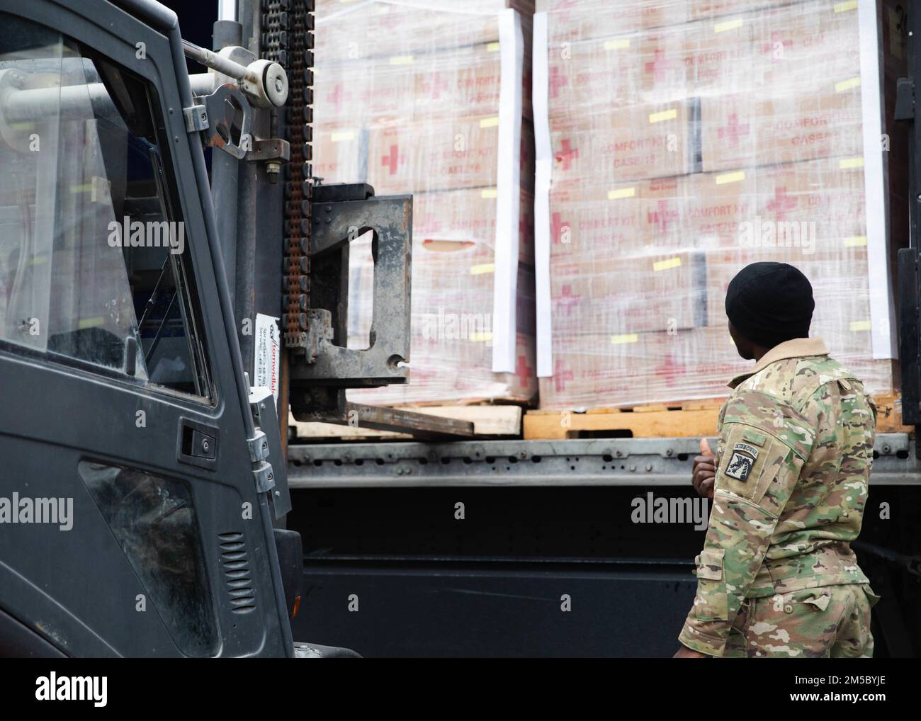 Paratroopers assigned to the 82nd Airborne Division, assist with unloading humanitarian goods in support of the United States Agency for International Development Stock Photo