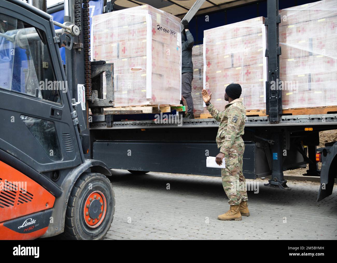 Paratroopers assigned to the 82nd Airborne Division, assist with unloading humanitarian goods in support of the United States Agency for International Development Stock Photo