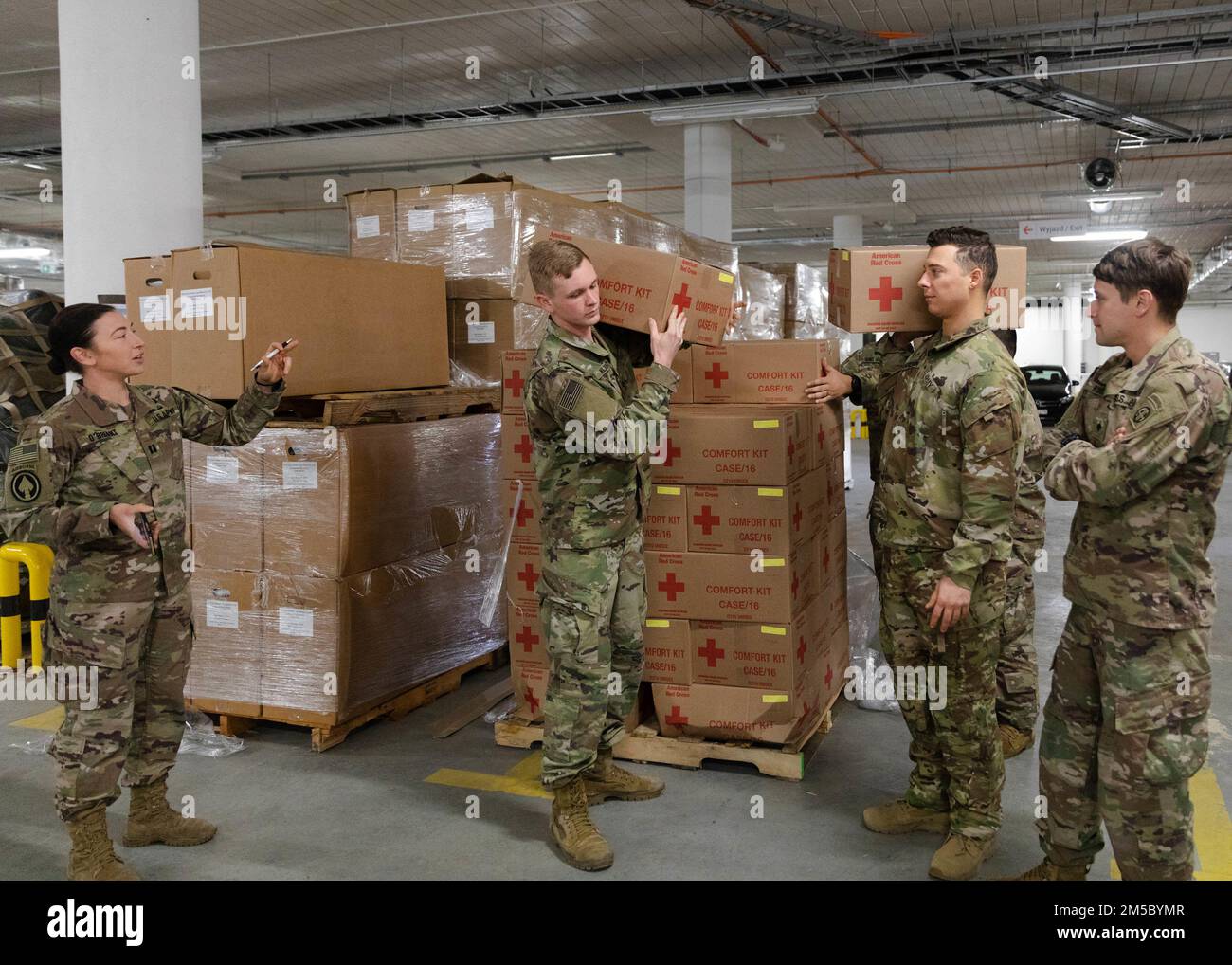 Paratroopers assigned to the 82nd Airborne Division, assist with unloading humanitarian goods in support of the United States Agency for International Development Stock Photo
