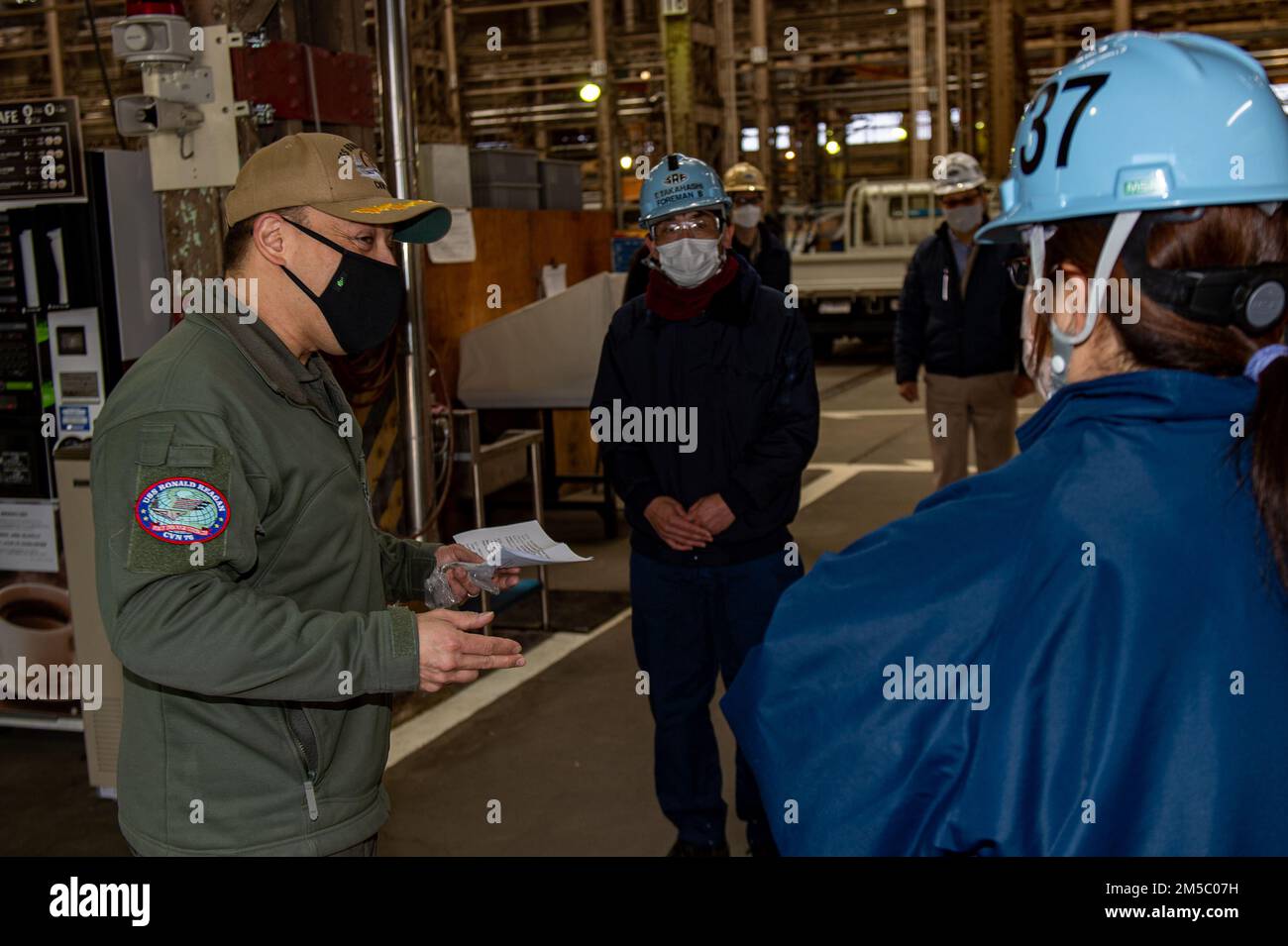 220225-N-SI601-1041 YOKOSUKA, Japan (Feb. 25, 2022) Capt. Fred Goldhammer, commanding officer of the U.S. Navy’s only forward-deployed aircraft carrier USS Ronald Reagan (CVN 76), addresses warehouse workers at Commander, Fleet Activities Yokosuka. Ronald Reagan, the flagship of Carrier Strike Group 5, provides a combat-ready force that protects and defends the United States, and supports alliances, partnerships and collective maritime interests in the Indo-Pacific region. Stock Photo