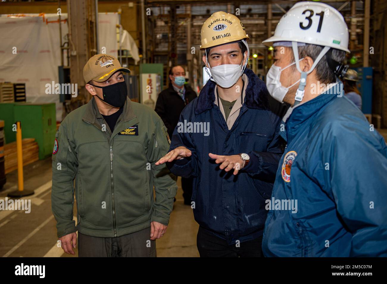 220225-N-SI601-1075 YOKOSUKA, Japan (Feb. 25, 2022) Capt. Fred Goldhammer, commanding officer of the U.S. Navy’s only forward-deployed aircraft carrier USS Ronald Reagan (CVN 76), receives a tour of a warehouse onboard Commander, Fleet Activities Yokosuka. Ronald Reagan, the flagship of Carrier Strike Group 5, provides a combat-ready force that protects and defends the United States, and supports alliances, partnerships and collective maritime interests in the Indo-Pacific region. Stock Photo