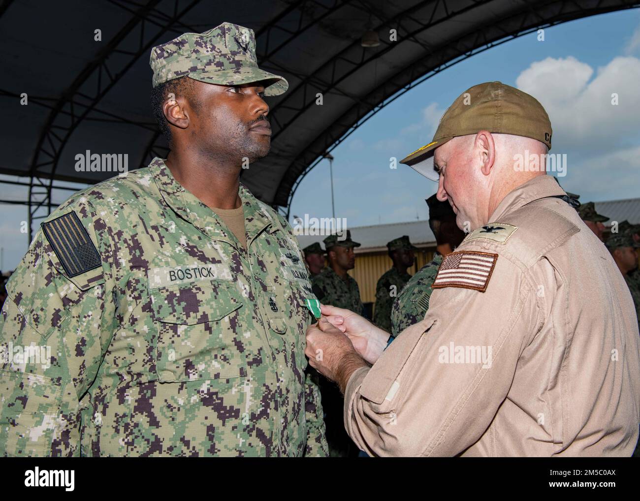 U.S. Navy Chief Hospital Corpsman Kevin Bostick, a Sailor from Washington, is presented The Navy and Marine Corps Commendation Medal by Capt. David Faehnle, the commanding officer of Camp Lemonnier, Djibouti during a ceremony held on camp February 25th. Stock Photo