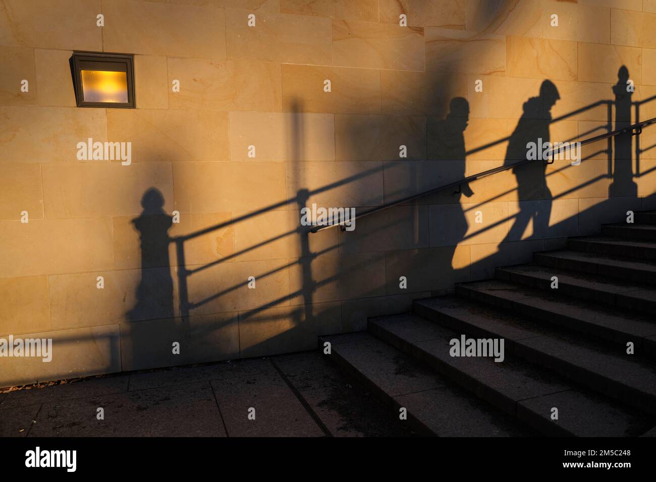 Germany, Berlin, 16. 12. 2021, shadow railing, stairs to Karl-Liebknecht-Bruecke, two men Stock Photo