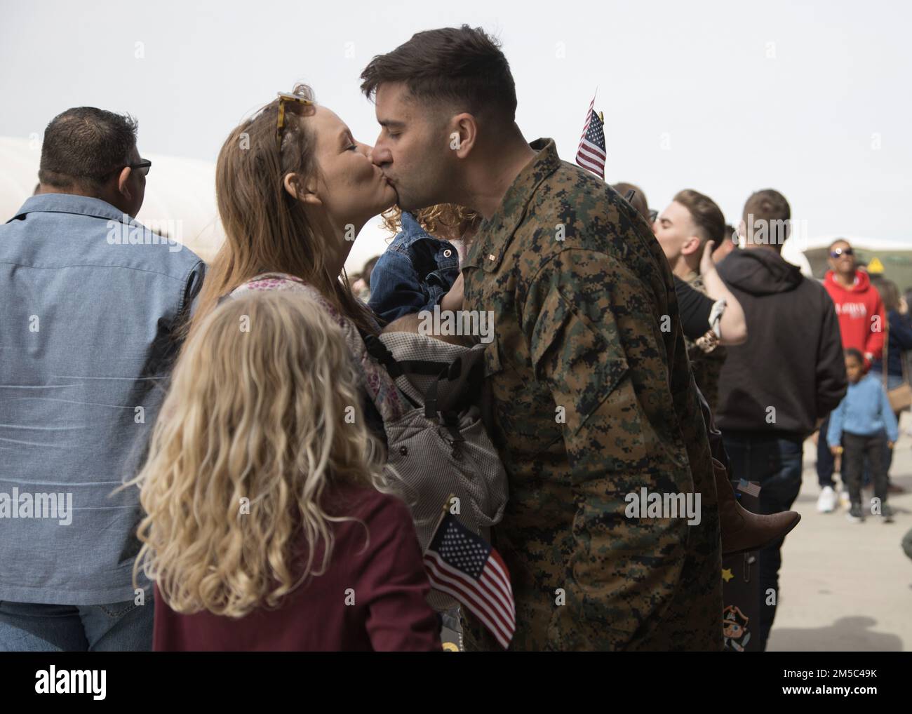 A U.S. Marine with Marine Attack Squadron (VMA) 214, 11th Marine Expeditionary Unit, reunites with his family during a homecoming event located at Marine Corps Air Station Yuma, Arizona, Feb. 27, 2022. VMA-214, the fixed squadron for the 11th MEU, returned from the unit’s Western Pacific 21.2 deployment in support of U.S. 3rd, 5th, and 7th Fleet area of operations as part of the Essex Amphibious Ready Group. Stock Photo