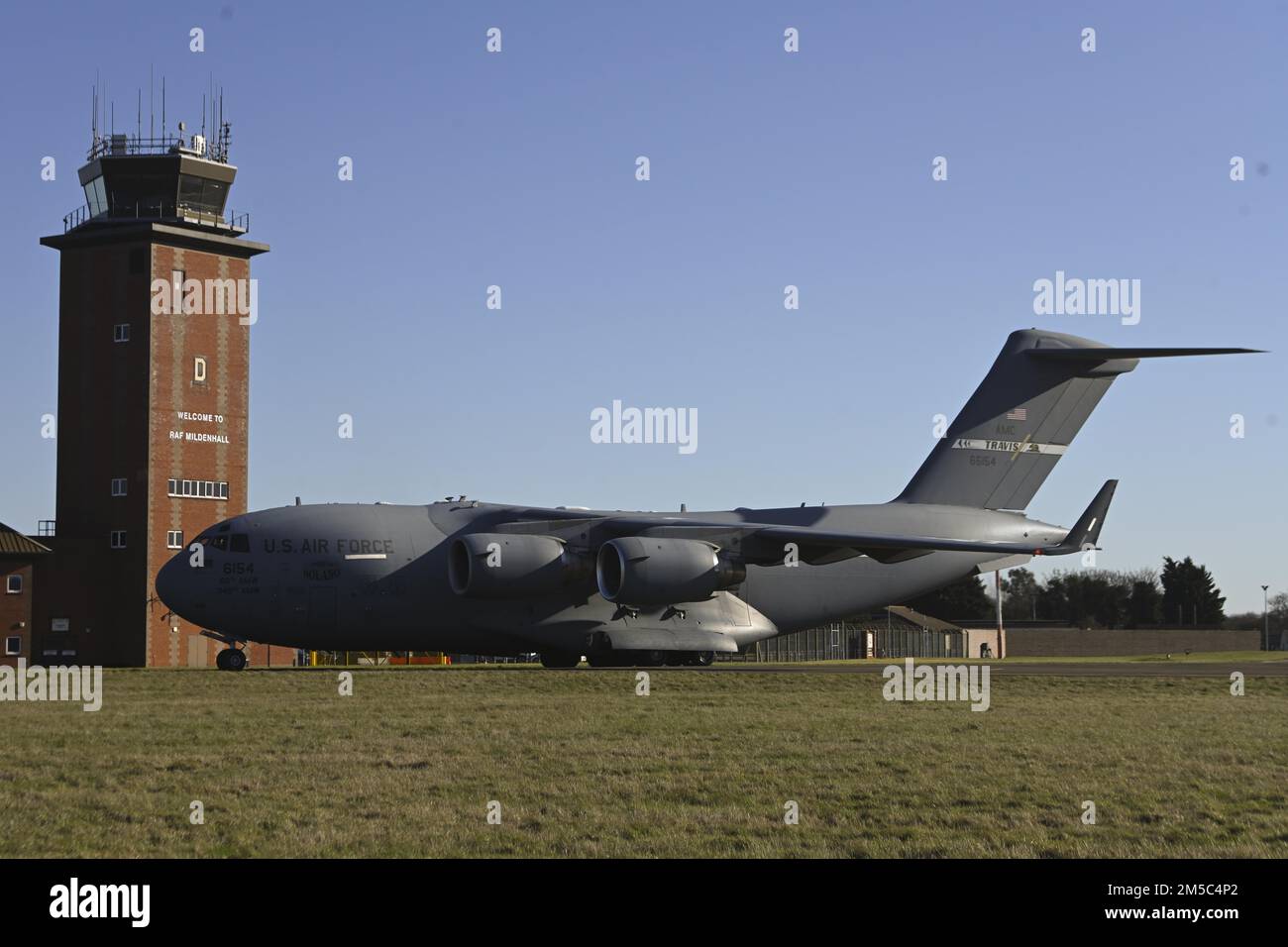 A U.S. Air Force C-17 Globemaster III aircraft assigned to the 60th Air Mobility Wing, Travis Air Force Base, Calif., taxis along the flightline after landing at Royal Air Force Mildenhall, England, Feb. 27, 2022. The aircraft landed at RAF Mildenhall after transporting cargo pallets to an air base in Norway. Stock Photo