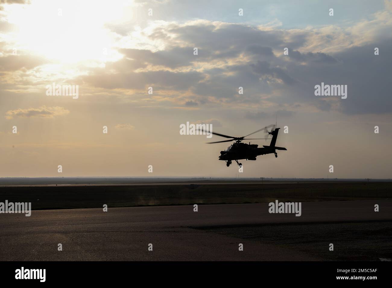 A U.S. Army AH-64 Apache, with 1st “Attack” Battalion, 227th Aviation Regiment, 11th Combat Aviation Brigade (CAB) hovers over a tarmac before a mission in the U.S. Central Command area of operations, Feb. 27, 2022. 11th CAB, mobilized as Task Force Eagle, is deployed in support of the Combined Joint Task Force – Operation Inherent Resolve mission to advise, assist and enable partnered forces in the enduring defeat of Da’esh, the common Arabic term for IS or ISIS, within designated areas of Iraq and Syria. Stock Photo
