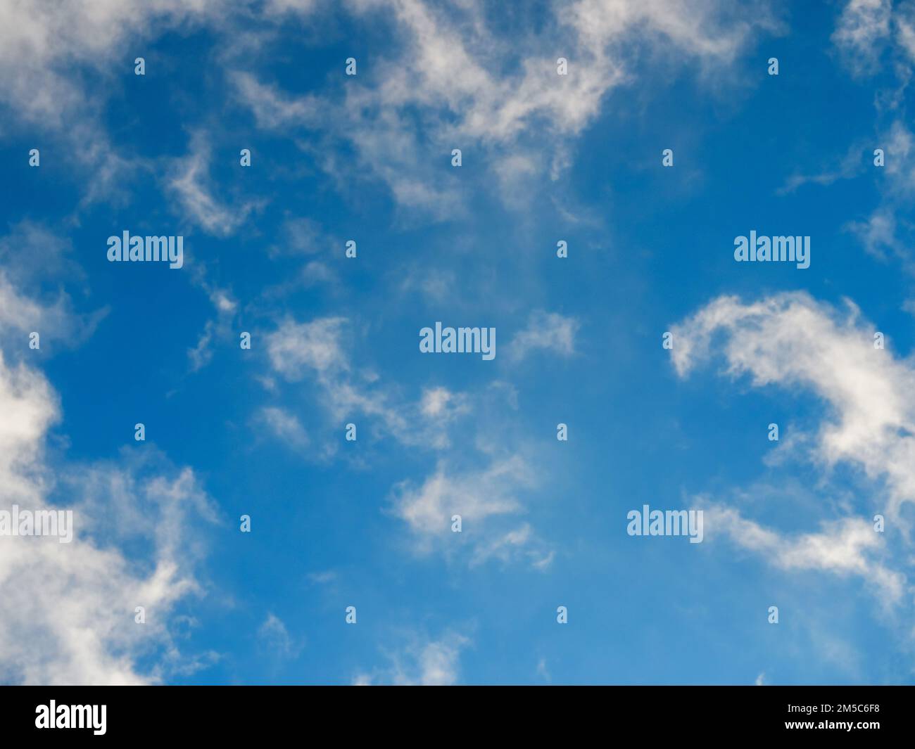 Fluffy soft clouds against a bright light blue sky Stock Photo - Alamy