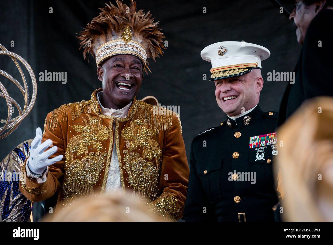Randolph Davis left King Zulu and Lt. Gen. David G. Bellon Commander of Marine Forces Reserve and Marine Forces South converse on stage during Lundi Gras at Woldenberg Park New Orleans Louisiana