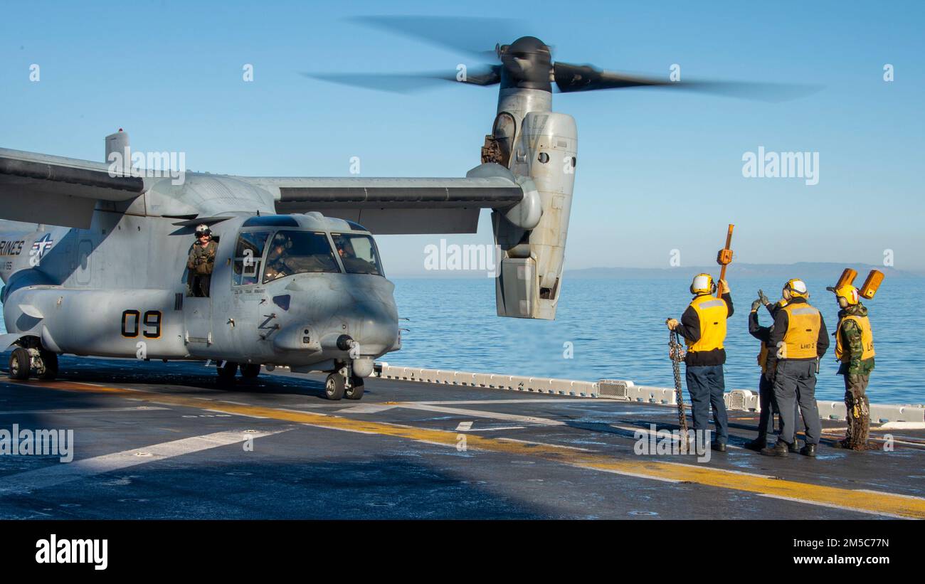 PACIFIC OCEAN (Feb. 28, 2022) Sailors assigned to Wasp-class amphibious assault ship USS Essex (LHD 2) remove chocks and chains from an MV-22B Osprey attached to Marine Medium Tiltrotor Squadron (VMM) 165 (Reinforced), 11th Marine Expeditionary Unit (MEU), during flight operations aboard Essex, Feb. 28, 2022. Sailors and Marines of Essex Amphibious Ready Group (ARG) and the 11th MEU are underway conducting routine operations in U.S. 3rd Fleet. Stock Photo