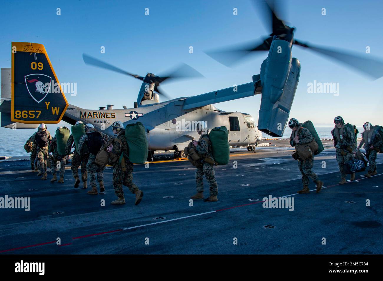 PACIFIC OCEAN (Feb. 28, 2022) Marines assigned to the 11th Marine Expeditionary Unit (MEU) board an MV-22B Osprey attached to Marine Medium Tiltrotor Squadron (VMM) 165 (Reinforced), 11th MEU, during flight operations aboard Wasp-class amphibious assault ship USS Essex (LHD 2), Feb. 28, 2022. Sailors and Marines of Essex Amphibious Ready Group (ARG) and the 11th MEU are underway conducting routine operations in U.S. 3rd Fleet. Stock Photo