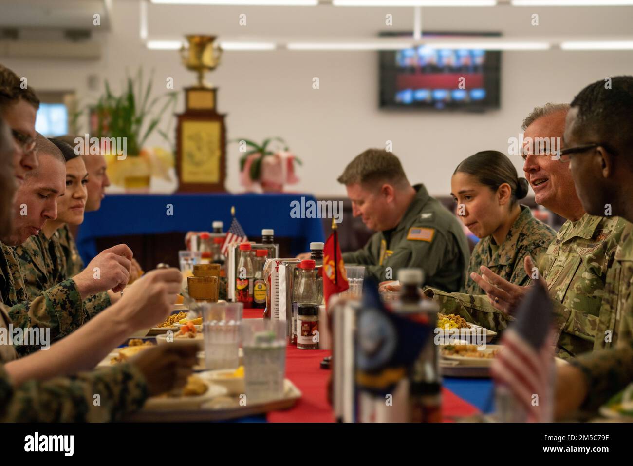 Marine Corps Air Station Iwakuni service members and U.S. Air Force Lt. Gen. Ricky N. Rupp, the commander of United States Forces Japan, have lunch during a visit to Marine Corps Air Station Iwakuni, Japan, March 1, 2022. Rupp visited squadrons and spoke with service members of all ranks at MCAS Iwakuni to better understand the air station’s commitment to the U.S.-Japan alliance and level of military readiness. MCAS Iwakuni is an advanced naval base which provides positional advantage, strengthened strategic alliances, and support to fleet operations and naval campaigns. Stock Photo