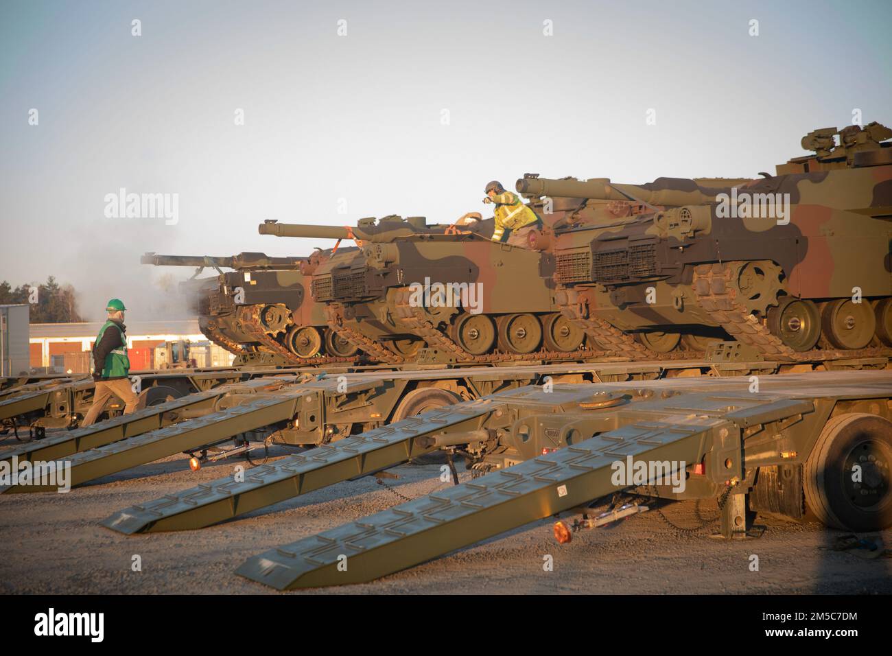 51st Composite Truck Company, 18th CSSB, 16th Sustainment Brigade transports multiple M1 Abrams tanks in Grafenwoehr, Germany, on Feb. 28, 2022.  U.S. Army Europe and Africa is drawing Army Prepositioned Stocks-2 in preparation to support 1st Armored Brigade Combat Team, 3rd Infantry Division deploying to Germany, as announced by the Department of Defense. A complete set for an Armored Brigade Combat Team is currently in the process of delivery to Grafenwoehr Training Area. Stock Photo