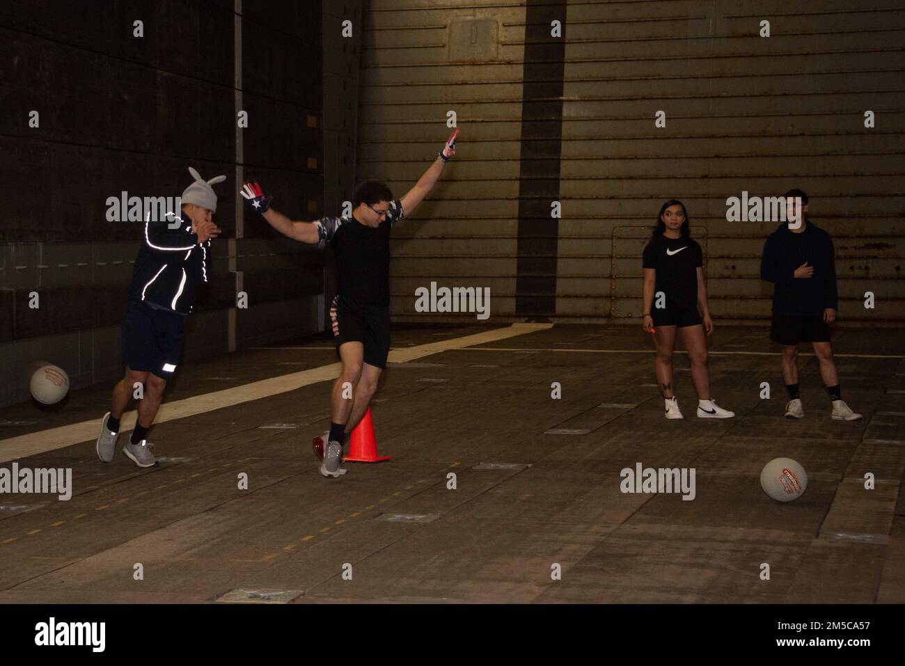 220228-N-XB010-1020 EAST CHINA SEA (Feb. 28, 2022) Sailors assigned to USS New Orleans (LPD 18) compete in a Morale, Wellness and Recreation sponsored dodgeball tournament in the ship’s well deck. New Orleans, part of the America Amphibious Ready Group, along with the 31st Marine Expeditionary Unit, is operating in the U.S. 7th Fleet area of responsibility to enhance interoperability with allies and partners and serve as a ready response force to defend peace and stability in the Indo-Pacific region. Stock Photo