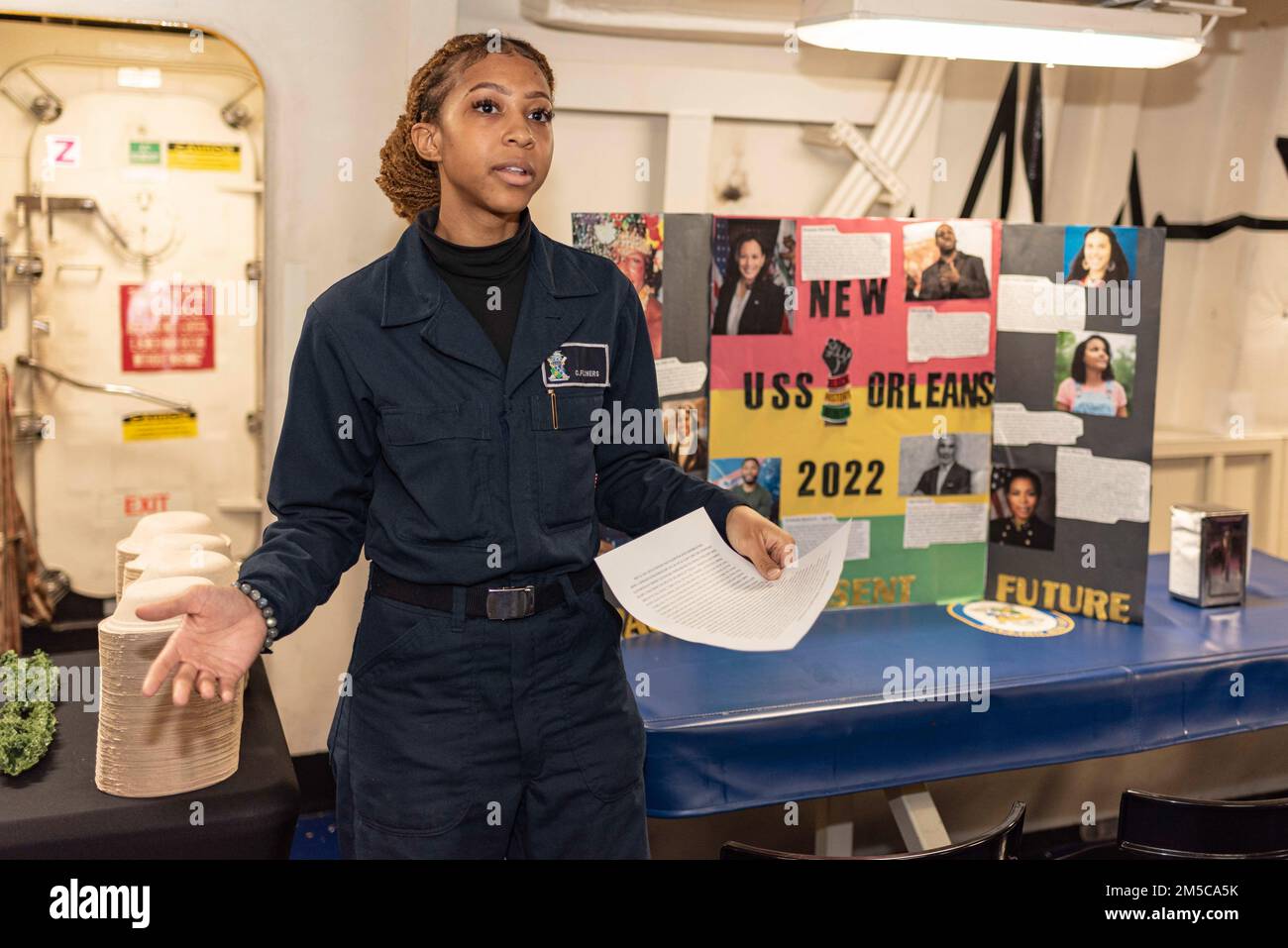 220228-N-XB010-1014 EAST CHINA SEA (Feb. 28, 2022) Logistics Specialist Seaman Cicely Flowers presents a speech during a Black History Month presentation by USS New Orleans’ (LPD 18) Diversity Committee. New Orleans, part of the America Amphibious Ready Group, along with the 31st Marine Expeditionary Unit, is operating in the U.S. 7th Fleet area of responsibility to enhance interoperability with allies and partners and serve as a ready response force to defend peace and stability in the Indo-Pacific region. Stock Photo