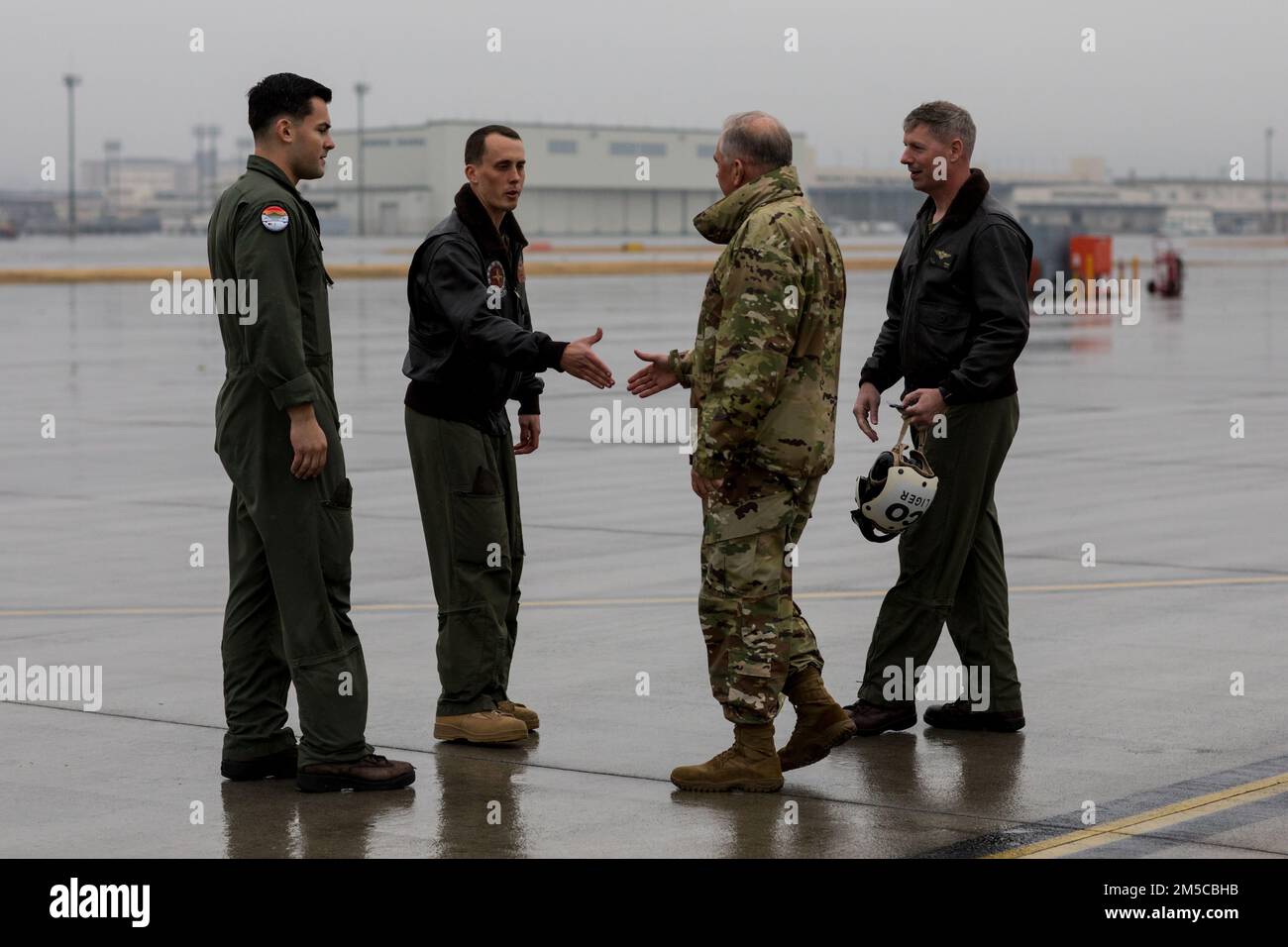 U.S. Air Force Lt. Gen. Ricky N. Rupp, right, commander of the United States Forces Japan, meets U.S. Marines with Marine Aerial Refueler Transport Squadron 152 during a KC-130 visit at Marine Corps Air Station (MCAS) Iwakuni, Japan, March 1, 2022. Rupp visited squadrons at MCAS Iwakuni to better understand the air station’s commitment to the U.S.-Japan alliance and level of military readiness. MCAS Iwakuni is an advanced naval base which provides positional damage, strengthened strategic alliances, and support to fleet operations and naval campaigns. Stock Photo