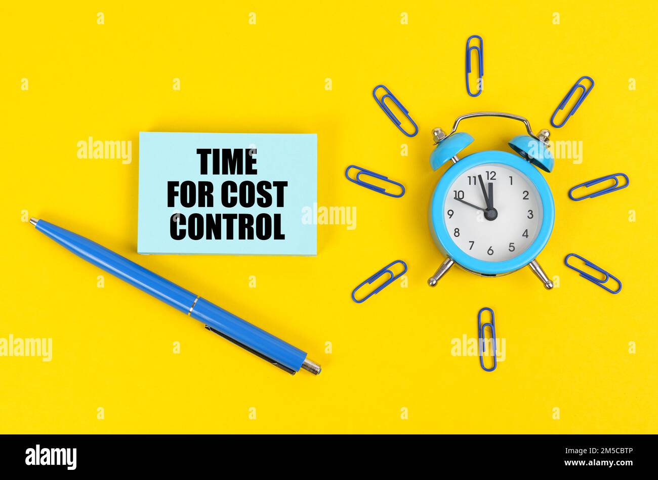 Business and education concept. On the yellow surface there is an alarm