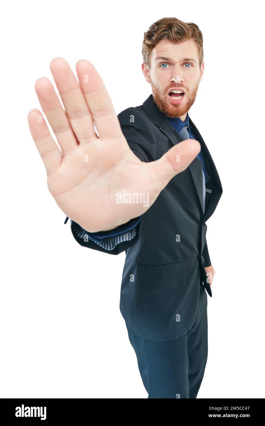 Hold it right there. Studio portrait of a young businessman gesturing to stop with his hand out against a white background. Stock Photo