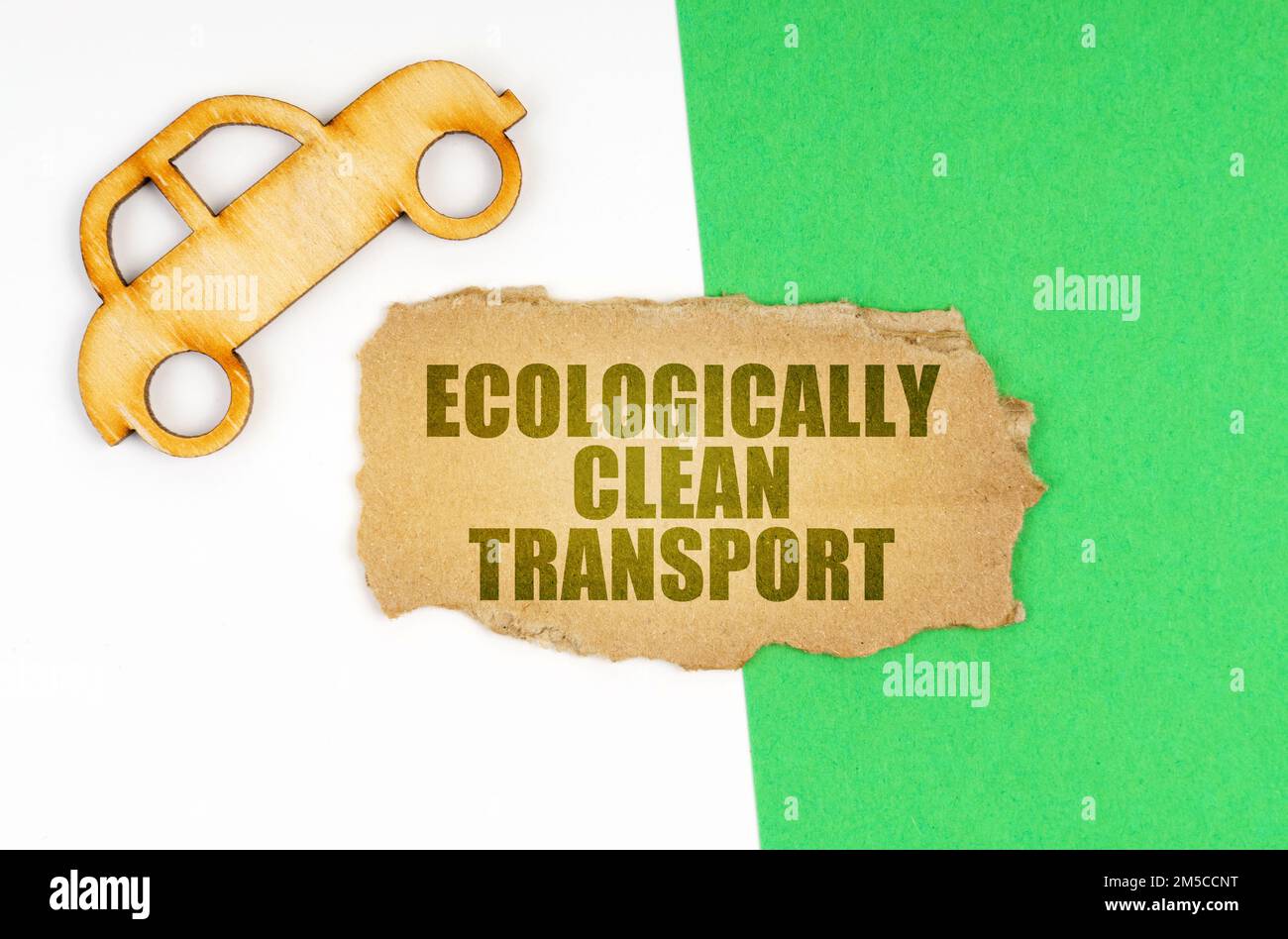 Ecological concept. On a white-green surface, a car and a cardboard ...