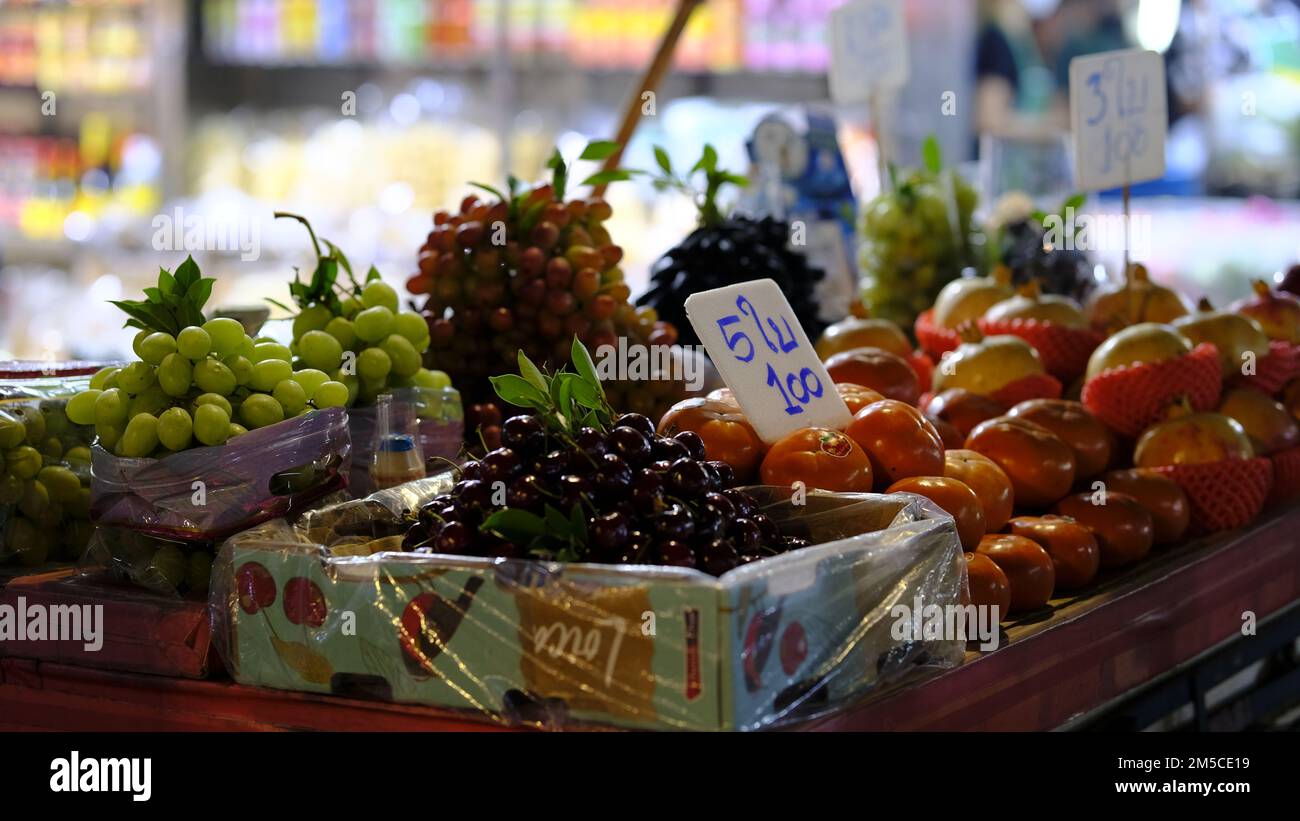 A variety of fresh fruits in boxes on sale at an outdoor market with ...