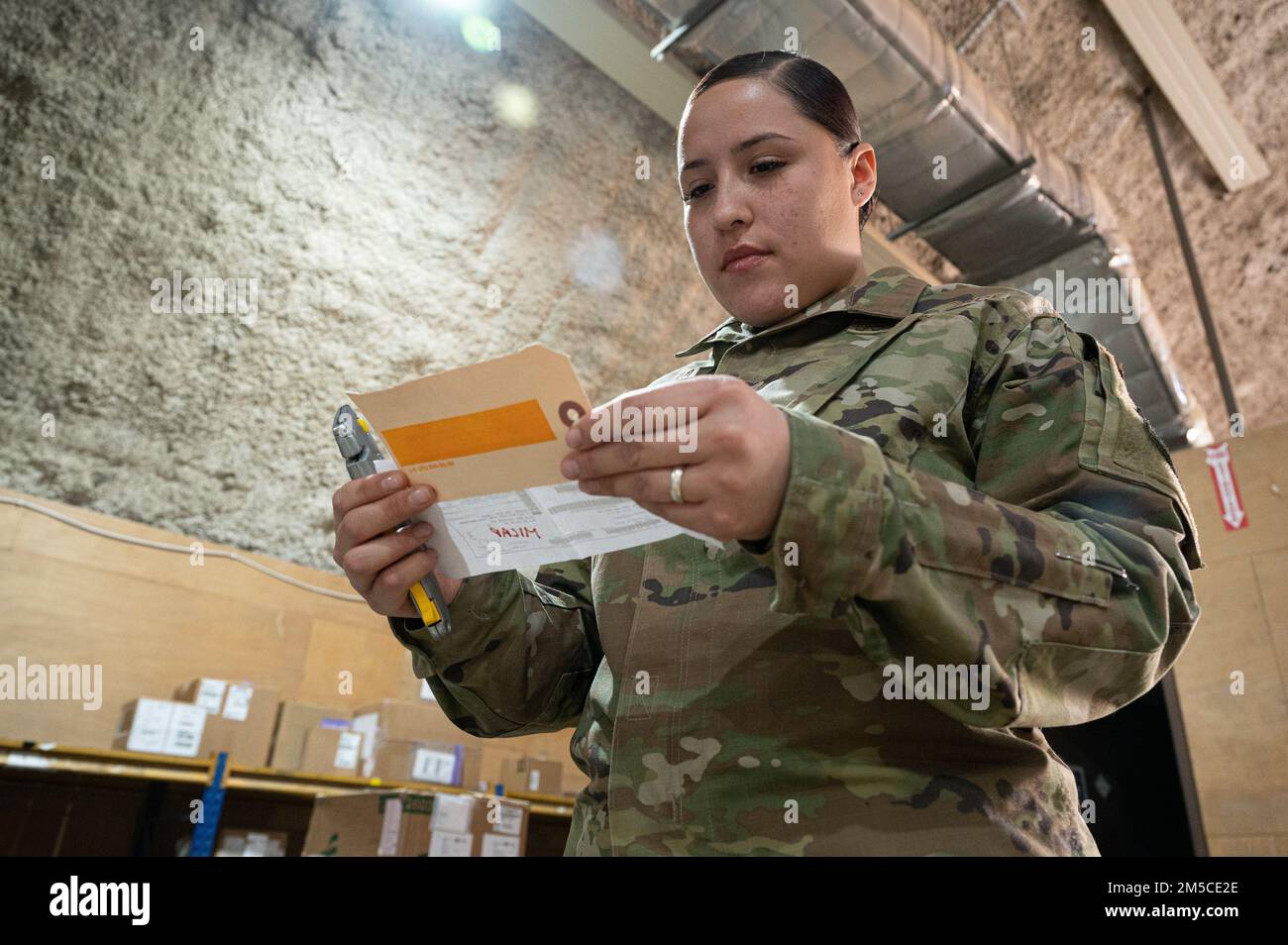 U.S. Air Force Senior Airman Ariana Herrera, inbound cargo technician, 386th Expeditionary Logistics Readiness Squadron, verifies items in a box with the DD Form 1348 documentation at the Traffic Management Operations warehouse at Ali Al Salem Air Base, Kuwait, March 1, 2022. The TMO office here is responsible for movement of cargo, assets and materials through the defense transportation system throughout the U.S. Central Command area of responsibility. Stock Photo
