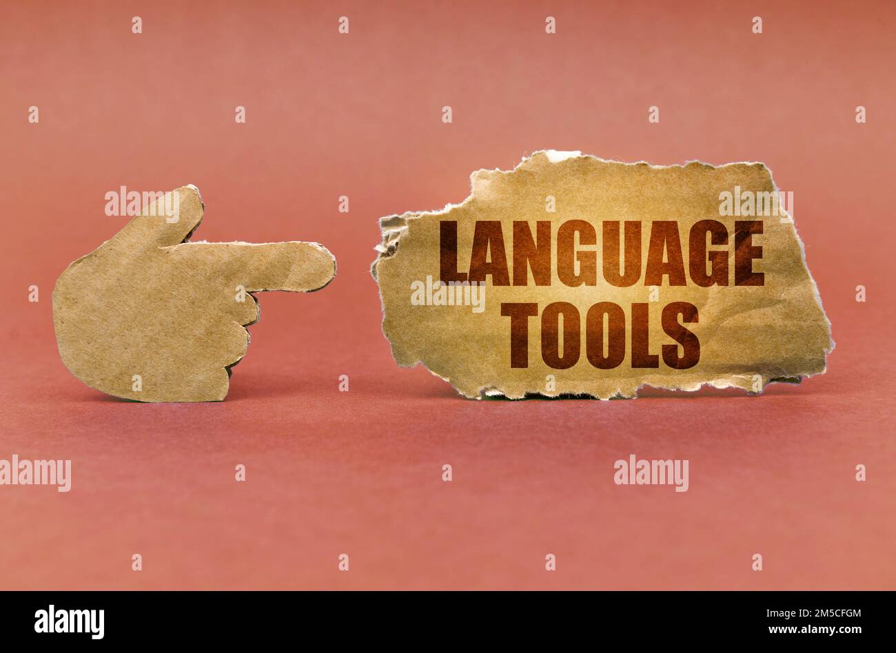 Education concept. On a brown surface, a cardboard hand points to a