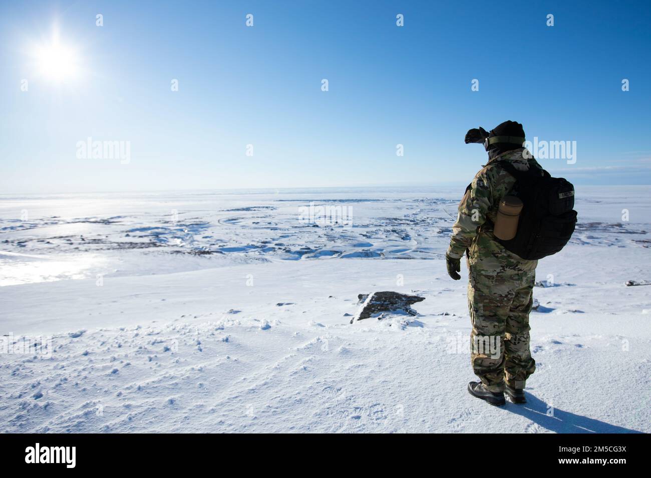 Pvt. Stanley Rodeski, Alaska State Defense Force, surveys the outskirts of Nome for a domain awareness exercise, Mar. 1. Alaska Exercise Arctic Eagle-Patriot 2022 increases the National Guard’s capacity to operate in austere, extreme cold-weather environments across Alaska and the Arctic region. AEP22 enhances the ability of military and civilian inter-agency partners to respond to a variety of emergency and homeland security missions across Alaska and the Arctic. Stock Photo