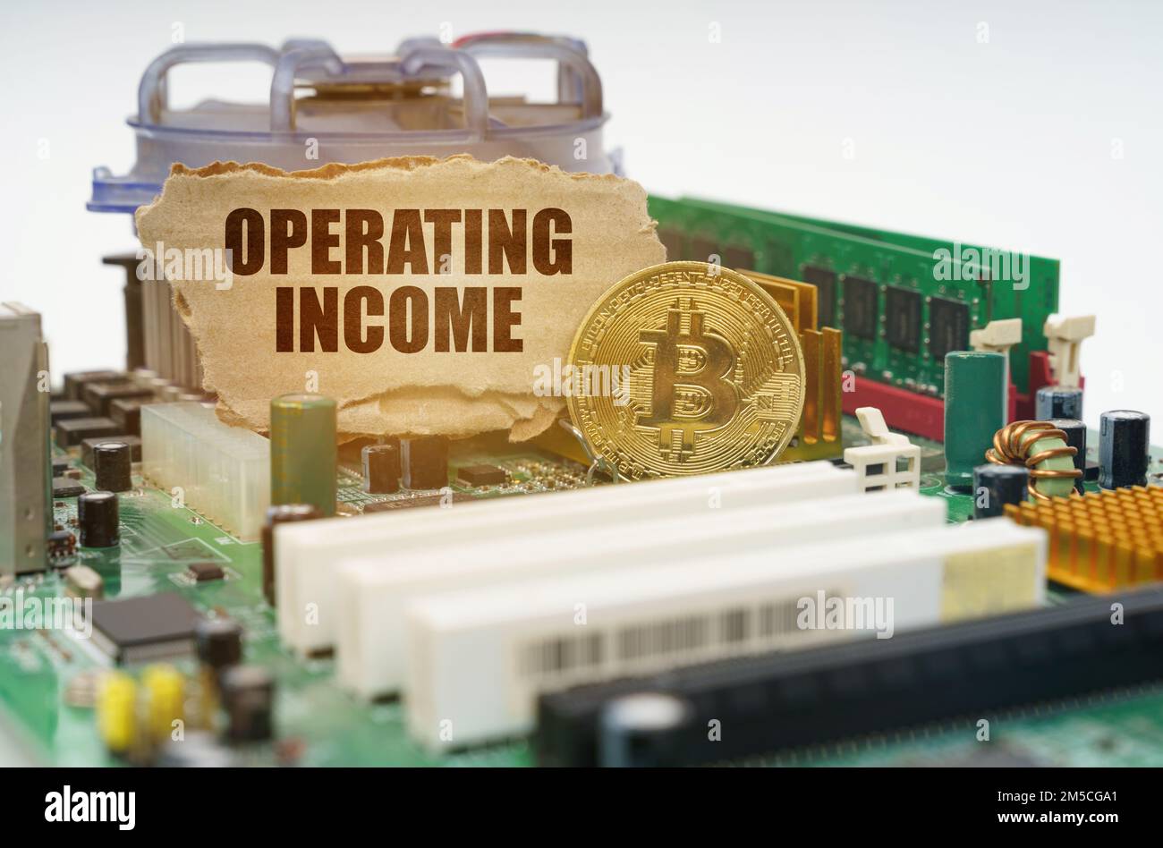 Crypto - business concept. On the motherboard lies a bitcoin coin and a ...