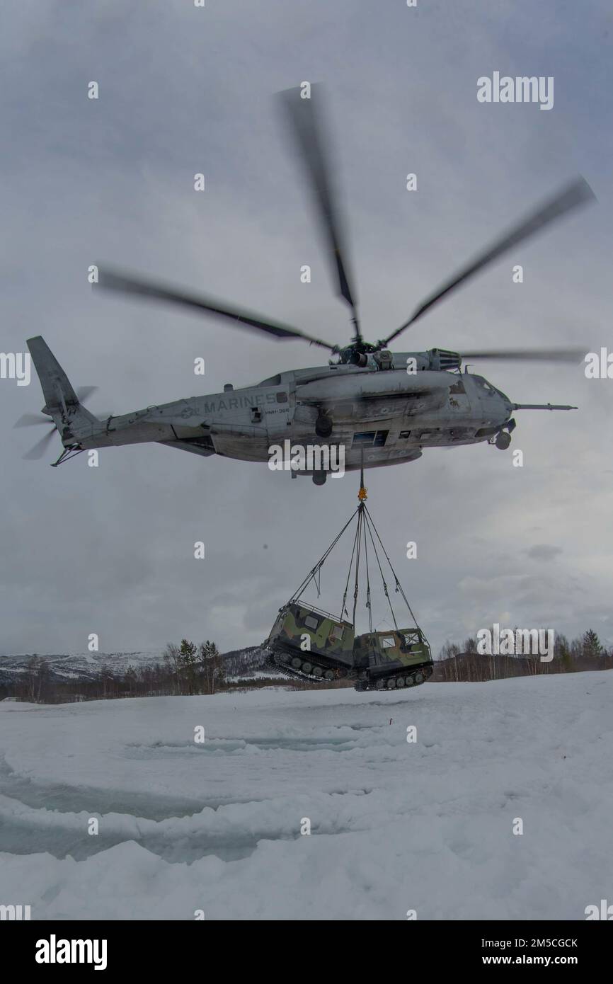A CH-53E Super Stallion with Marine Heavy Helicopter Squadron 366 (HMH-366), 2nd Marine Aircraft Wing, lifts a Norwegian Bandvagn 206 in preparation for Exercise Cold Response 2022, Bardufoss, Norway, Feb. 28, 2022. Exercise Cold Response '22 is a biennial Norwegian national readiness and defense exercise that takes place across Norway, with participation from each of its military services, as well as from 26 additional North Atlantic Treaty Organization (NATO) allied nations and regional partners. Stock Photo